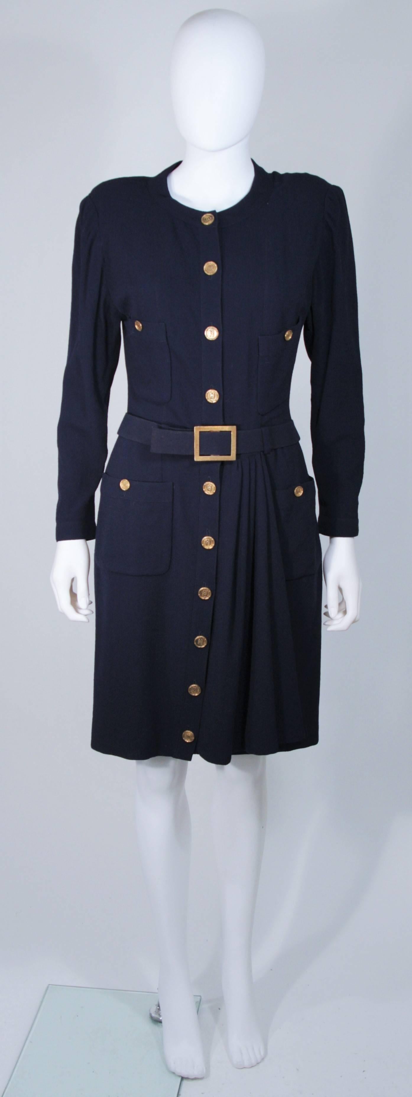  This Chanel dress is composed of a navy fabric and features gold textured 