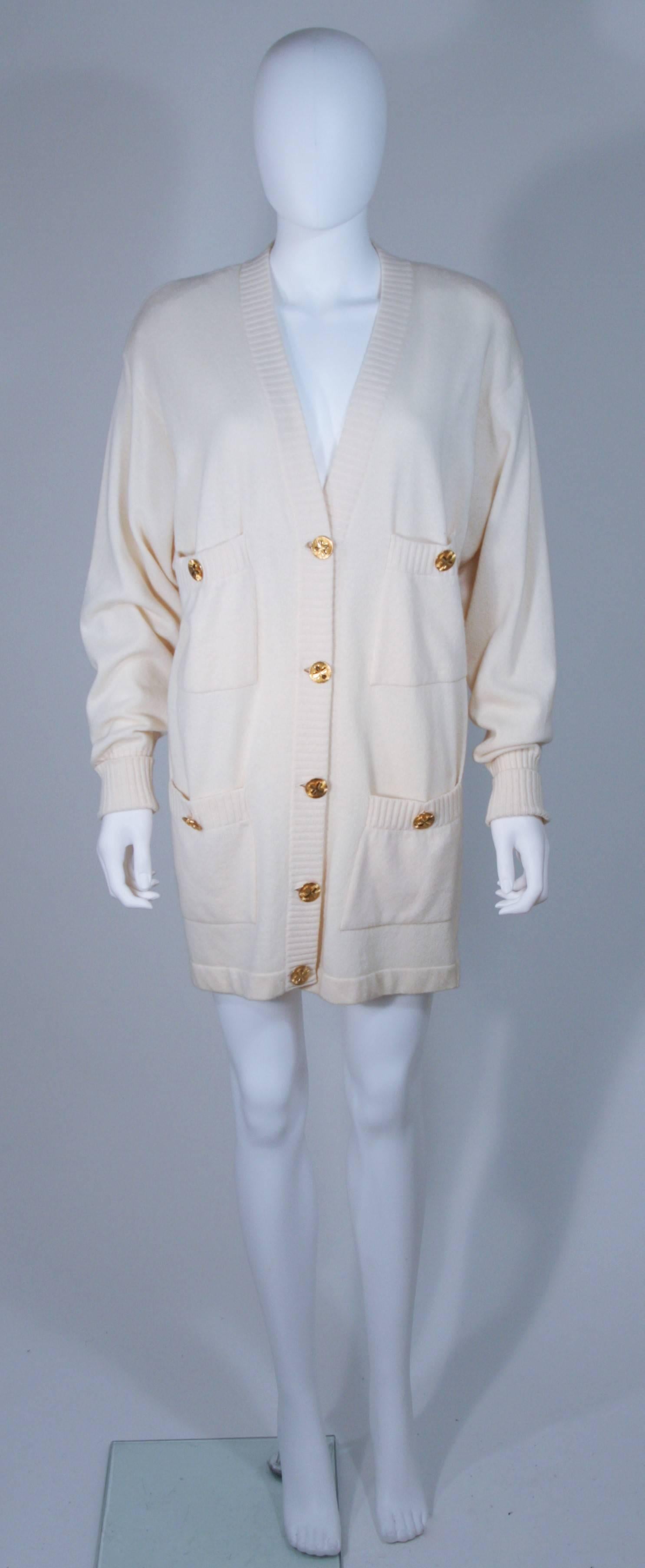  This Chanel cardigan is composed of a cream cashmere and features gold center front buttons with four front pockets. In excellent vintage condition. 

**Please cross-reference measurements for personal accuracy.

Measures (Approximately)
Size
