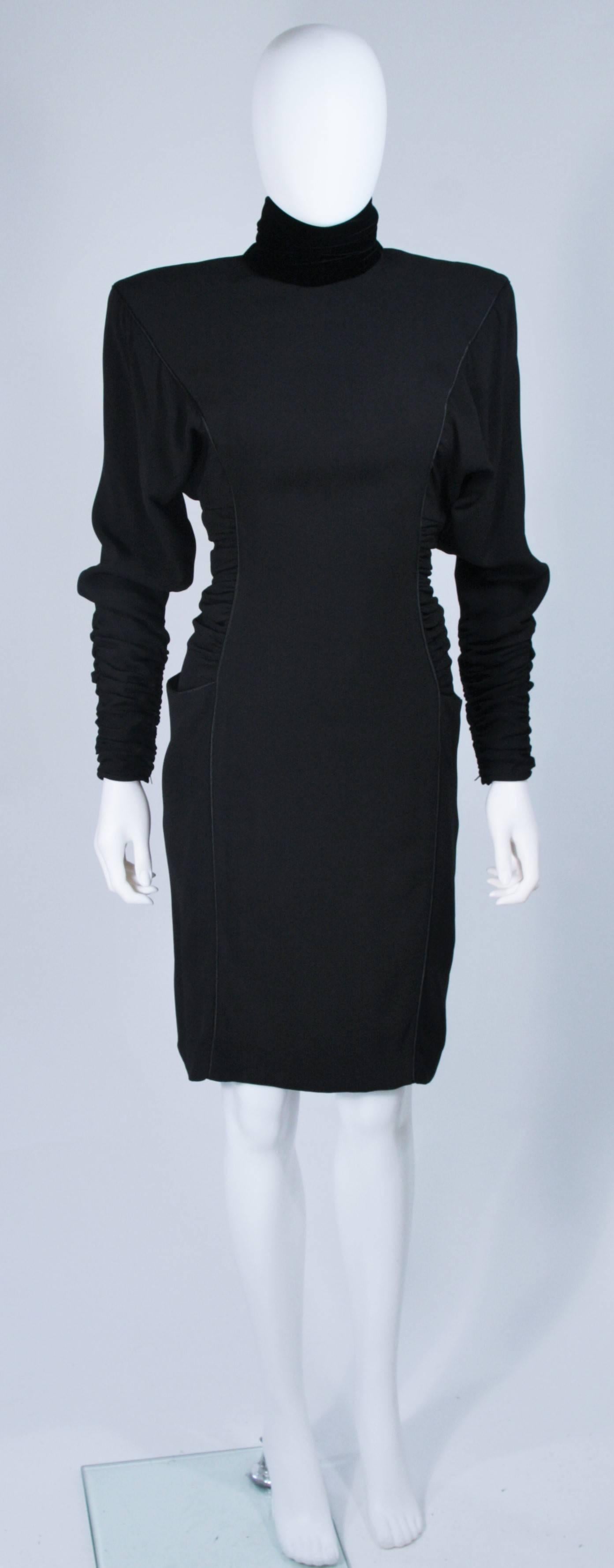  This Emanuel Ungaro dress is composed of a black silk with princess piping details and features a velvet mock collar. There is rouching and gathering at the sides and sleeves. Side pockets and a center back closure with faceted black buttons. In