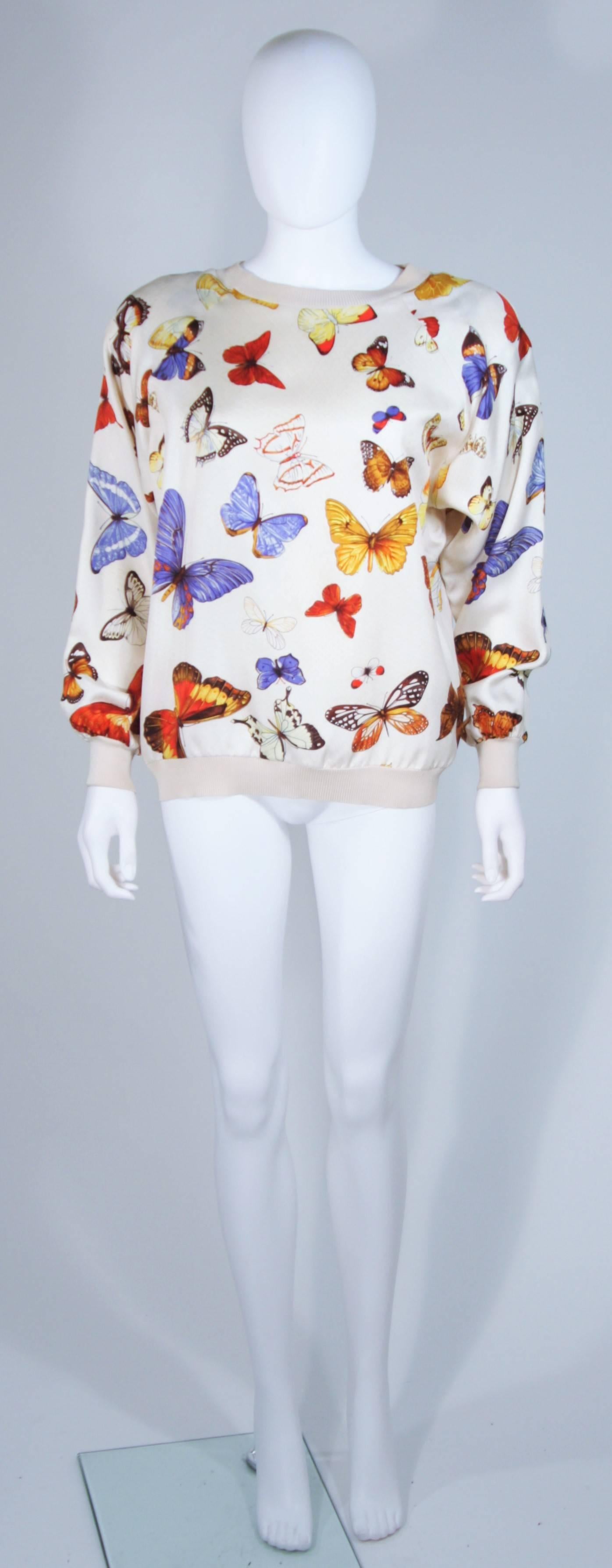 This Hermes design is available for viewing at our Beverly Hills Boutique. We offer a large selection of evening gowns and luxury garments. 

 This sweater is composed of a cream silk with butterfly print. The pullover style sweater features very