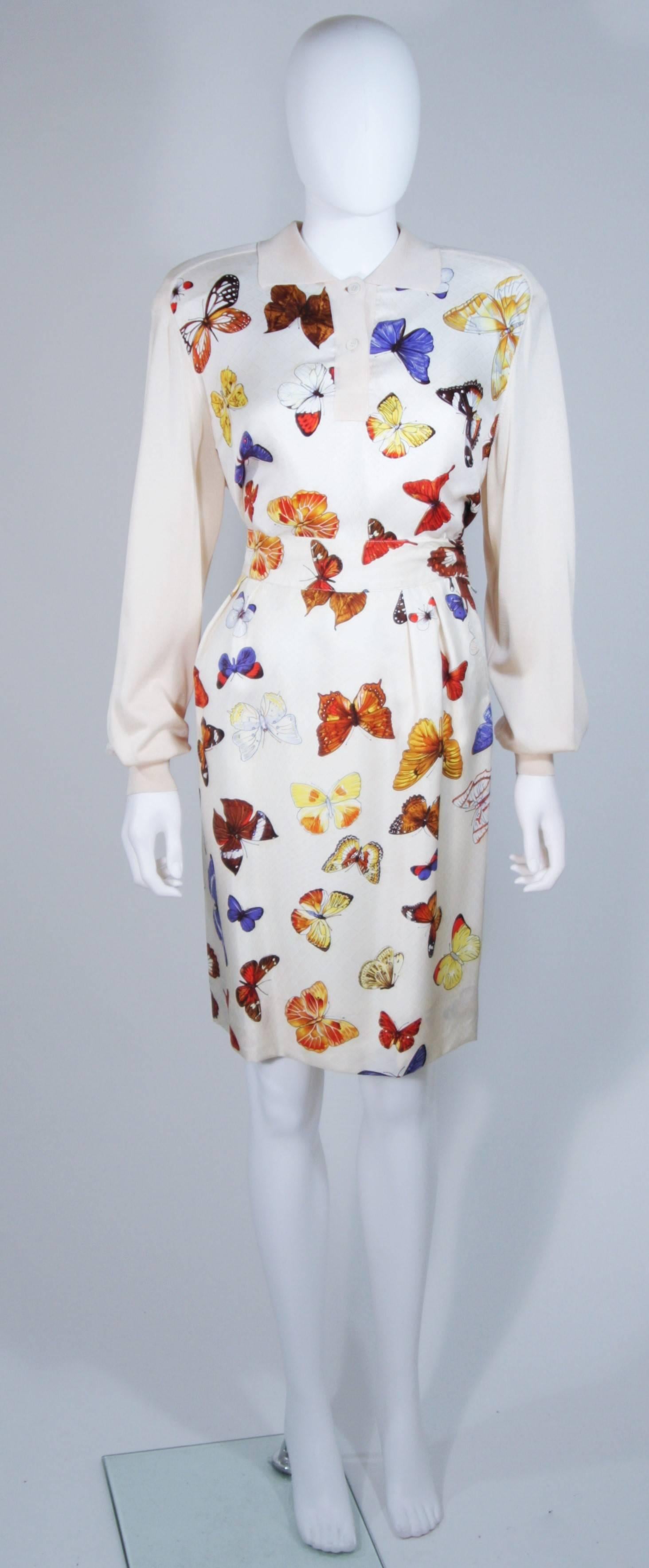 This Hermes skirt set is composed of a cream silk with butterfly print. The pullover style sweater features a classic collar with 2 gold button closures. The pleat front skirt has side pockets and a zipper closure. In excellent vintage condition.
