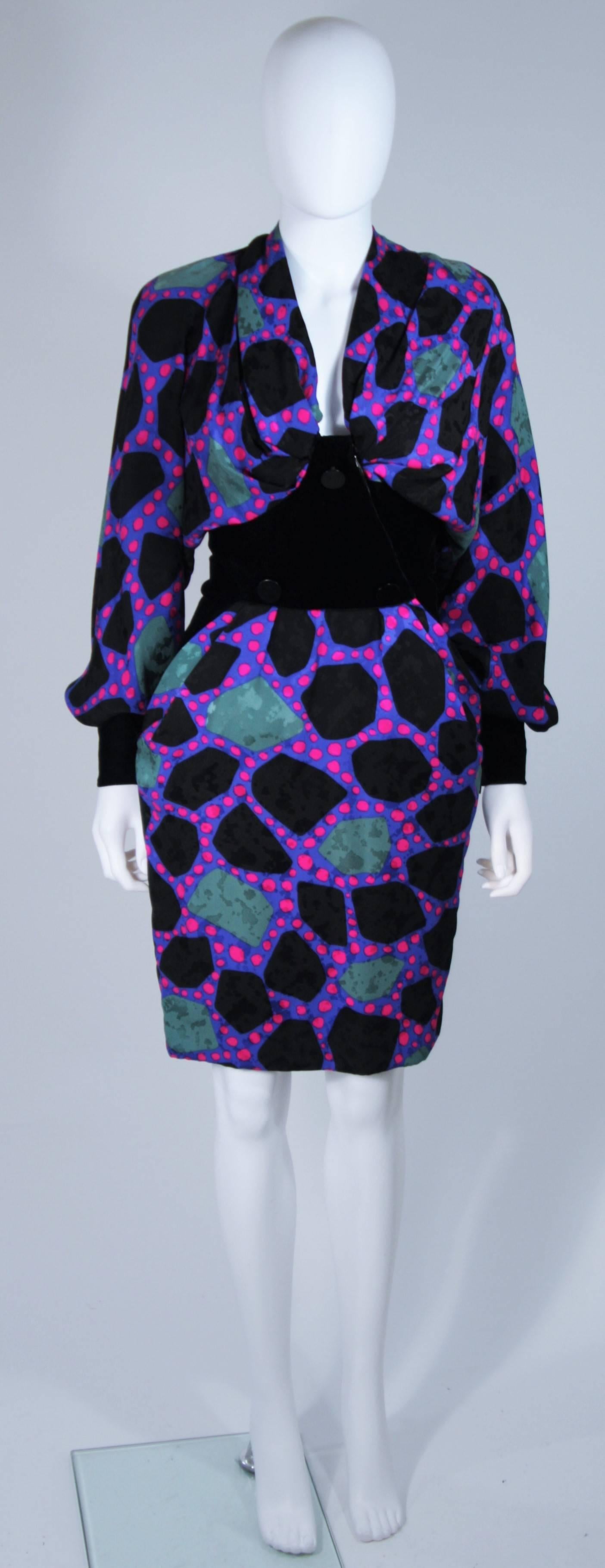  This Jacqueline De Ribes Couture dress is composed of a printed silk in a wonderfully contrasting magenta, purple, teal, and black combination. The draped design features a velvet waist, sleeves, and button applique. There are front pockets,