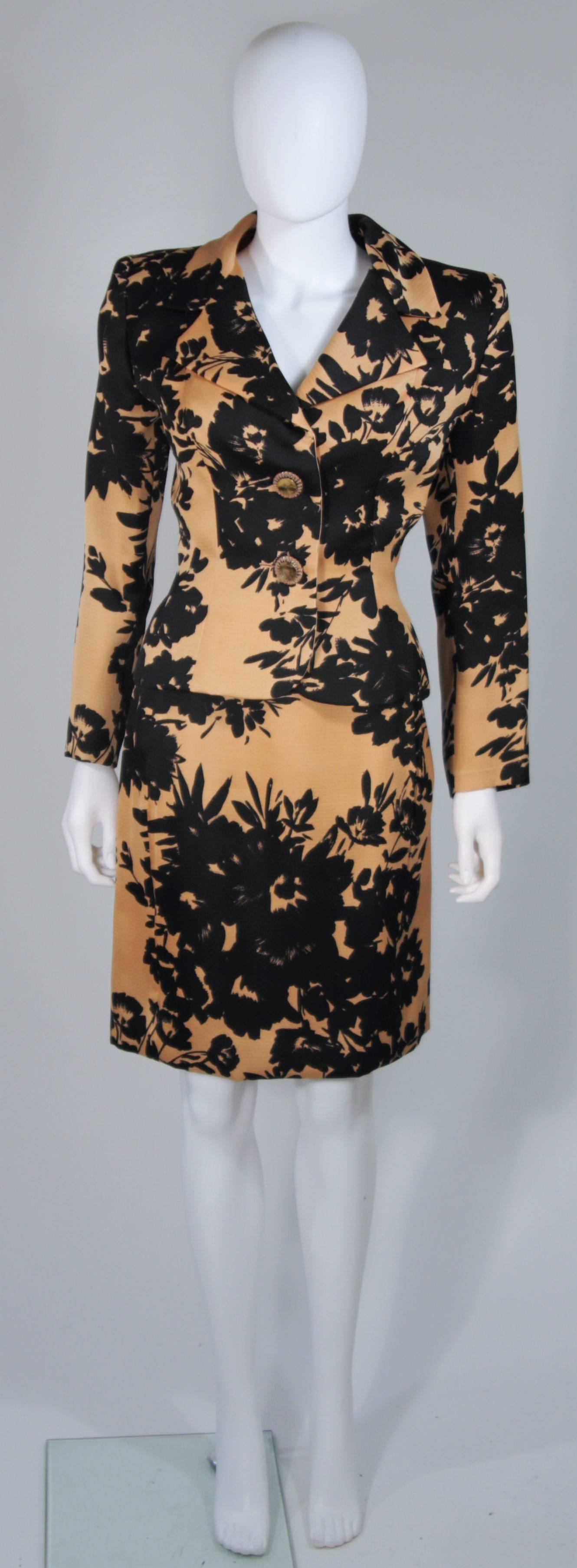  This Givenchy Couture skirt suit is composed of a apricot brown and black floral print fabric. with silk lining. The jacket has large rhinestone button closures. The pencil style skirt has a zipper closure. In excellent vintage condition.