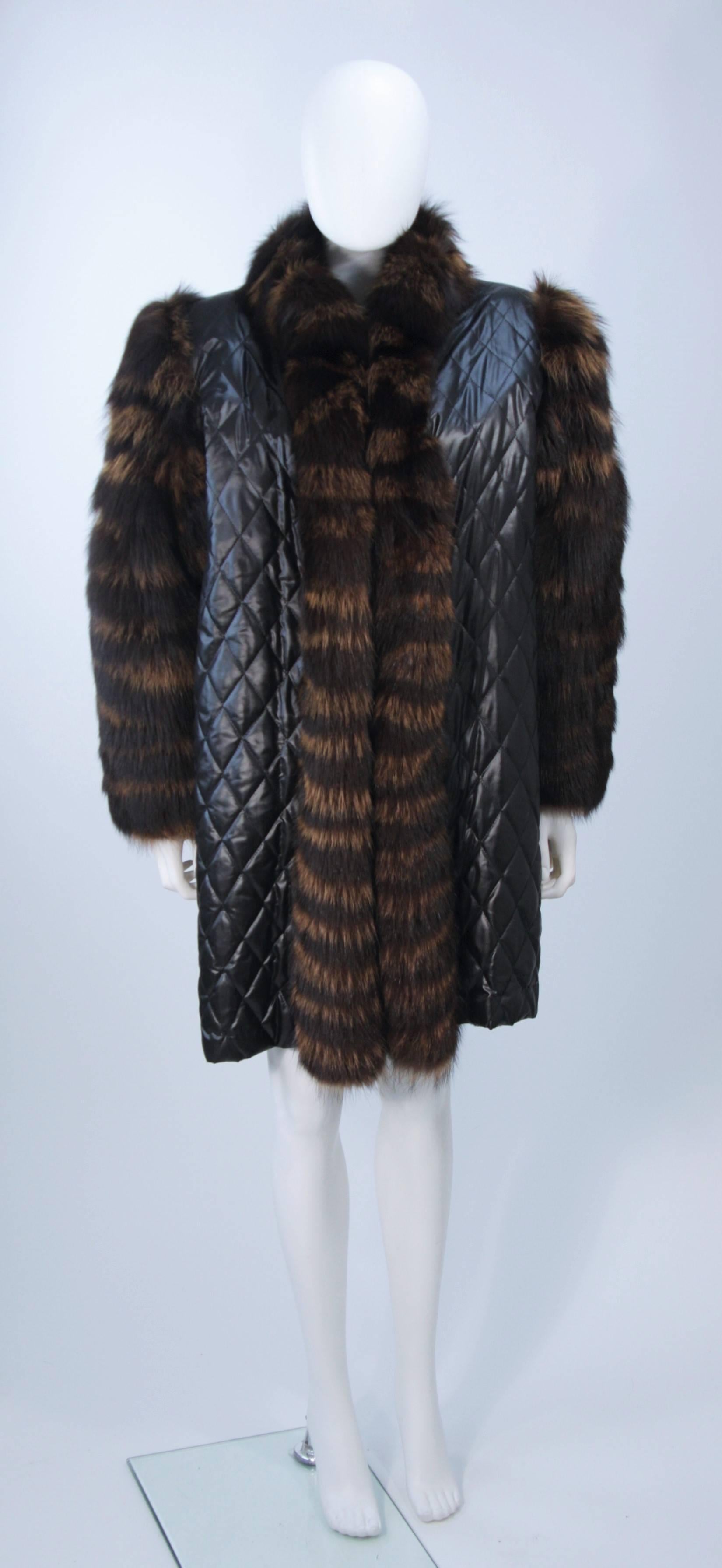 This Yves Saint Laurent Couture coat is composed of a supple quilted polyester in black with cognac/ brown hue fox fur trim and sleeves. Features sheared beaver lining and an open style design with pockets. In excellent vintage condition.