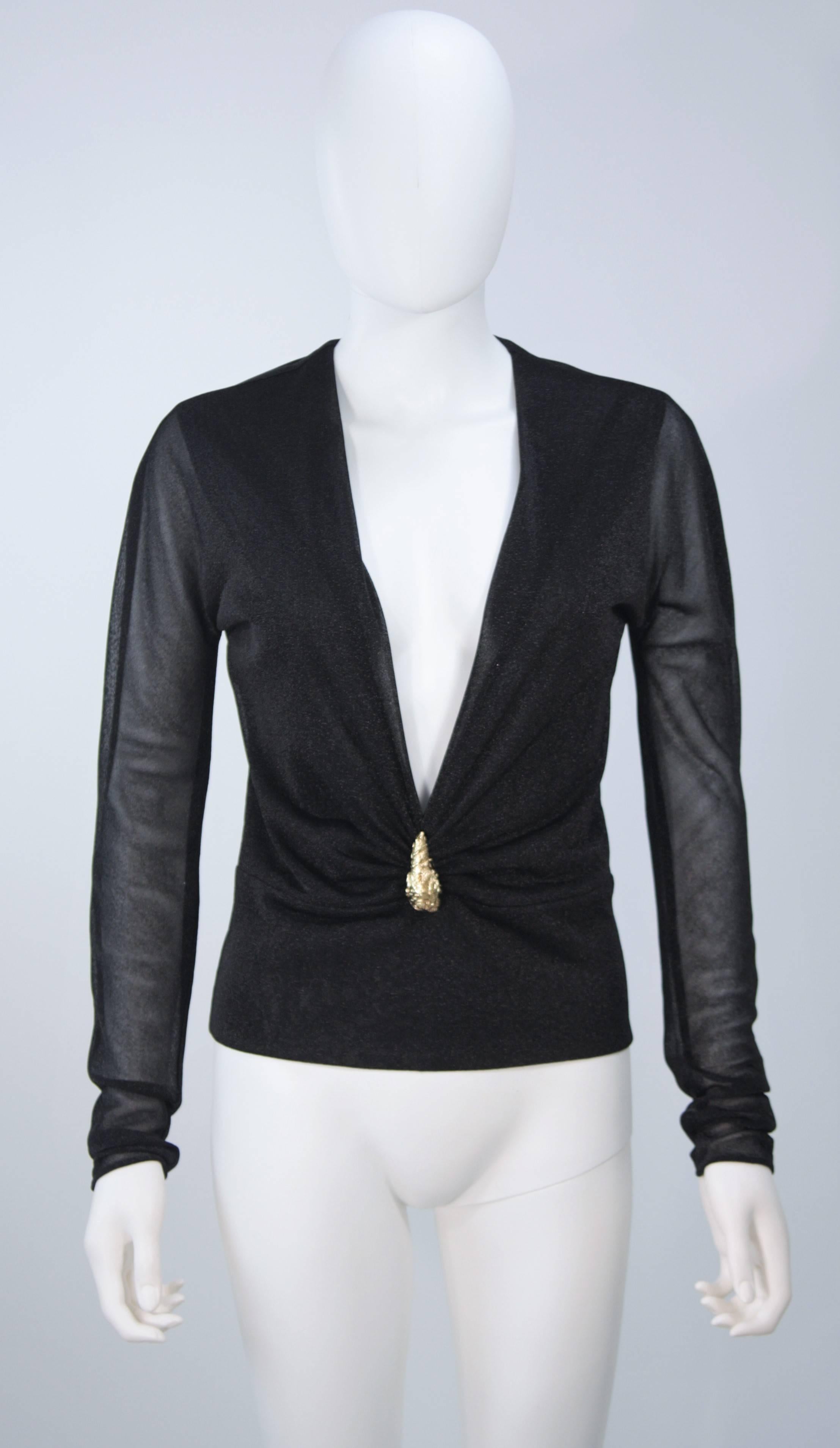 This Gucci blouse is composed of a stretch Lurex in black. Features a plunging neckline with gold lion head hardware. In excellent vintage condition. 

**Please cross-reference measurements for personal accuracy. Size in description box is an