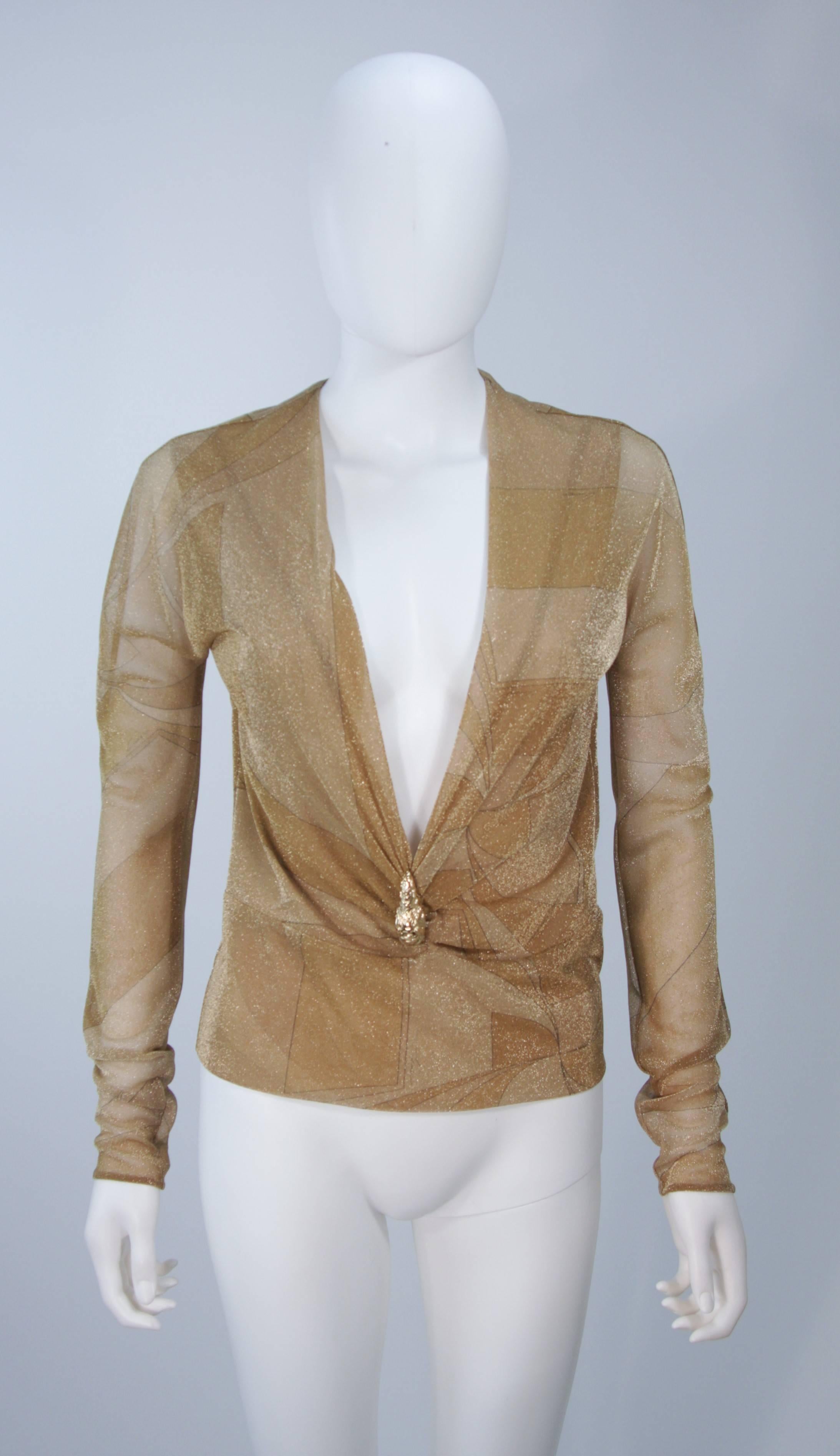 This Gucci design is available for viewing at our Beverly Hills Boutique. We offer a large selection of evening gowns and luxury garments. 

 This blouse is composed of a stretch Lurex in hues of gold with a geometric print. Features a plunging