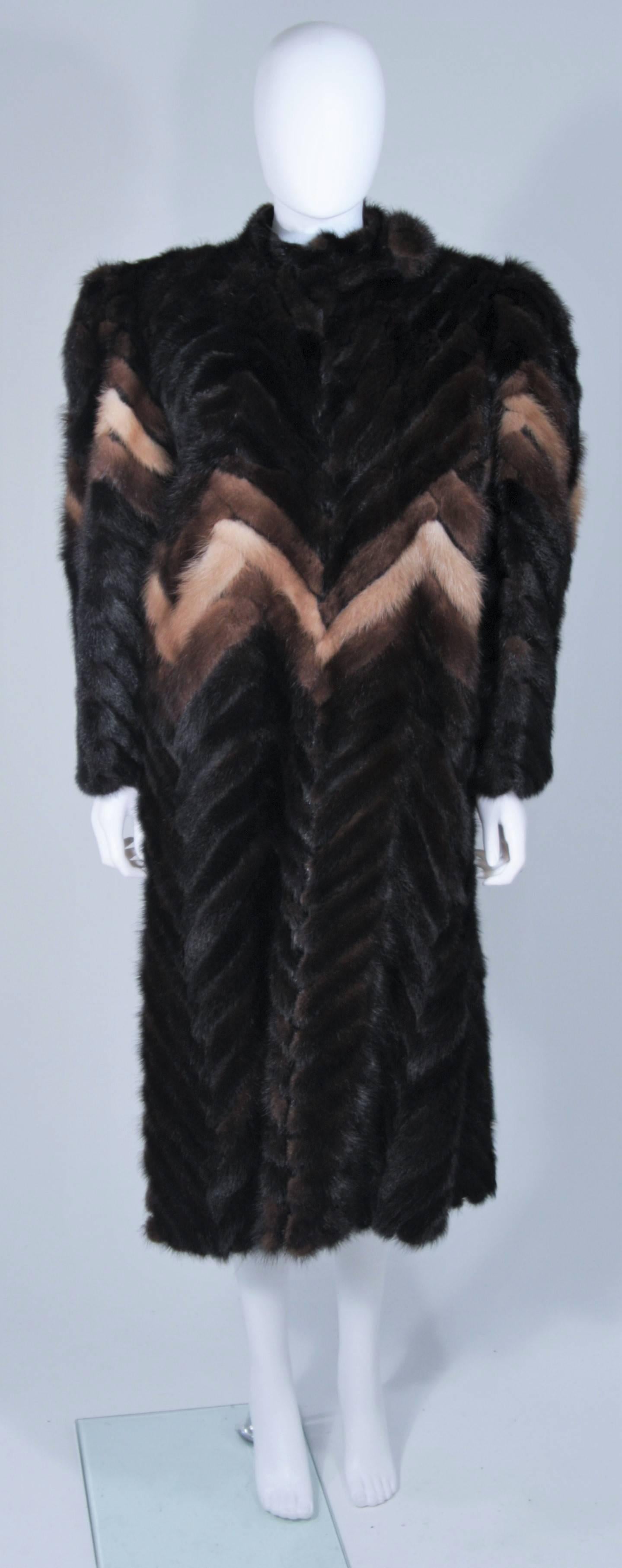  This Ted Lapidus Couture coat is composed of mink in hues of natural browns with a chevron pattern. There is a center front top large closure and hook & eyes throughout. There are side pockets. In excellent vintage condition, monogrammed with