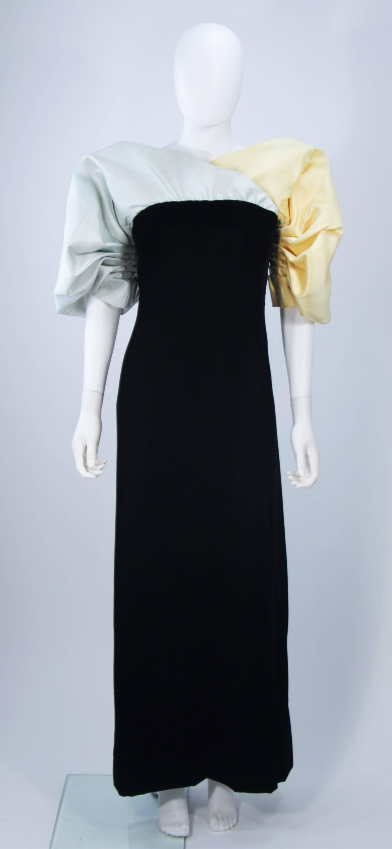  This Jacqueline De Ribes gown is composed of a black velvet with blue and yellow silk sleeves. There is an interior bustier foundation. In excellent vintage condition. 

**Please cross-reference measurements for personal accuracy. Size in