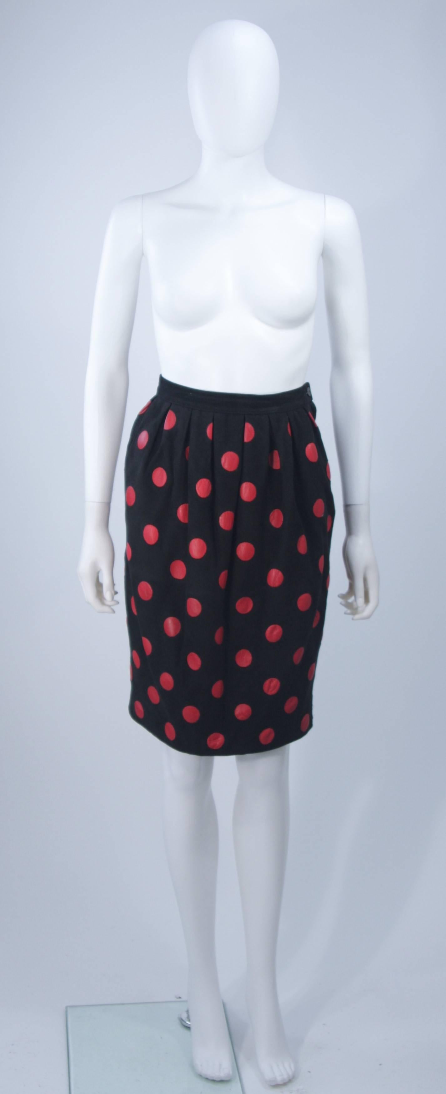  This Valentino skirt is composed of a black suede with red leather polka dots. Features gathers at the waist and a side zipper closure. In excellent vintage condition. 

**Please cross-reference measurements for personal accuracy. 

Measures