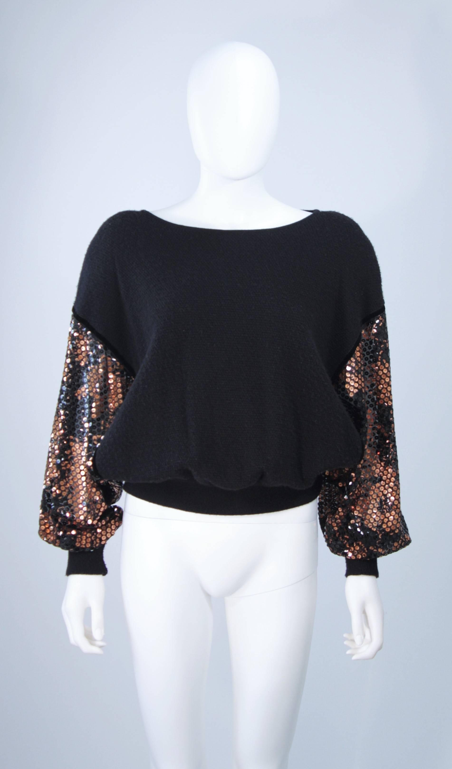  This Valentino sweater is composed of a black wool with sheer sequined sleeve. The pull on style sweater features dolman sleeves. In excellent vintage condition. 

**Please cross-reference measurements for personal accuracy. Size in description