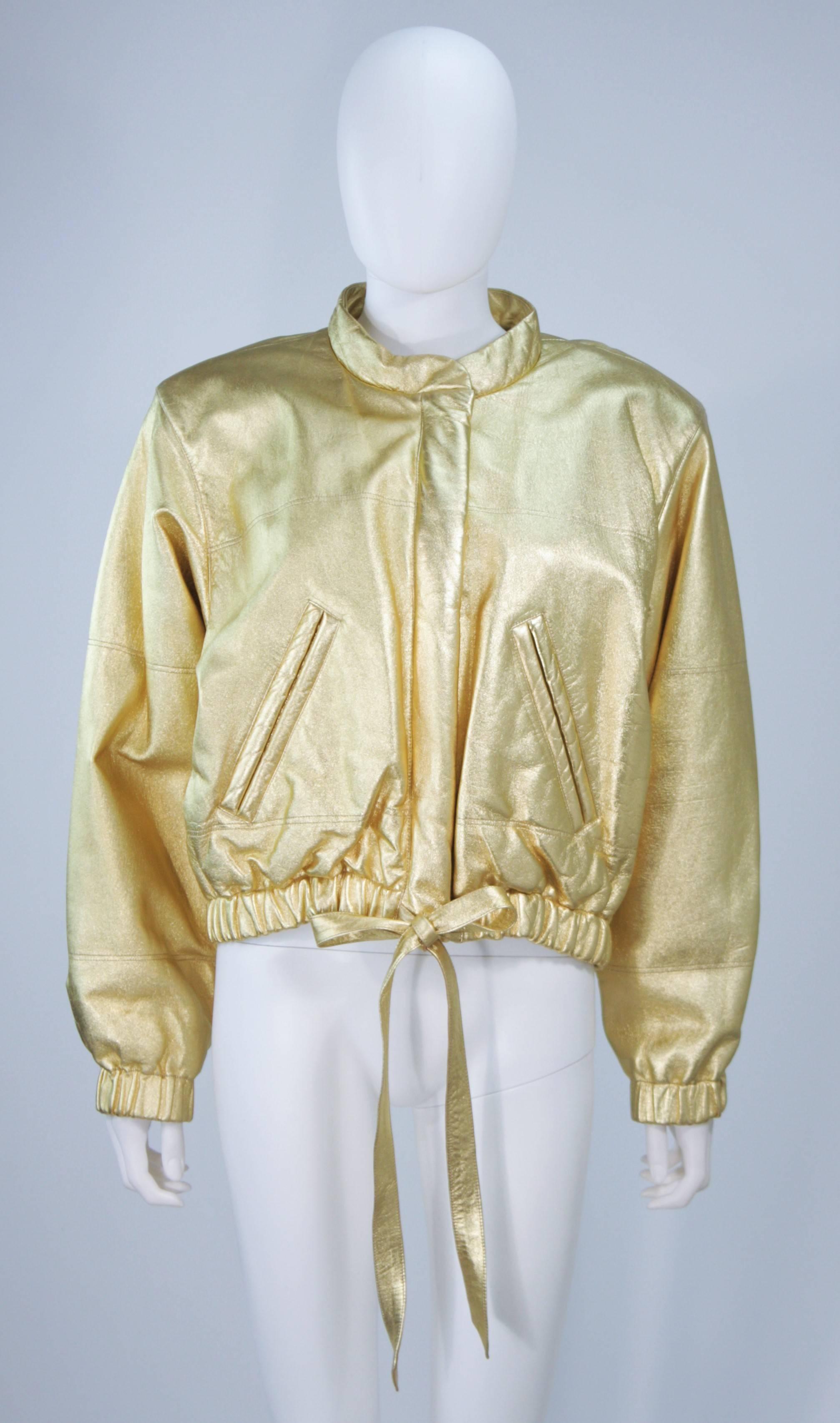  This Yves Saint Laurent jacket is composed of a gold metallic leather. Features a center front zipper, side pocket, and elastic at the waist/cuffs. In excellent vintage condition.

**Please cross-reference measurements for personal accuracy. Size