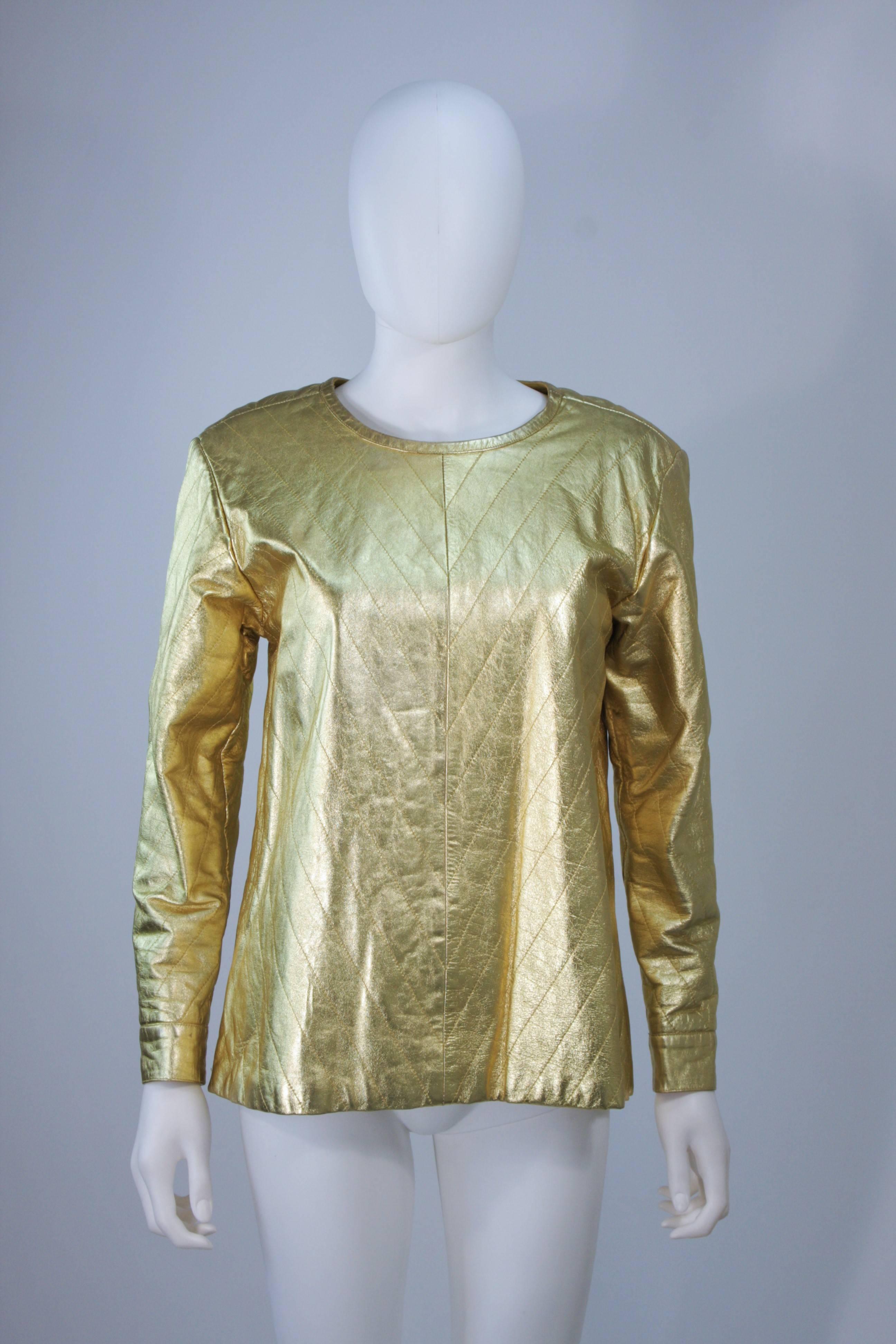  This Yves Saint Laurent top is composed of a gold metallic leather in a quilted pattern. The pull on style features a center back neck button. In excellent vintage condition.

This YSL gold leather top is from an extensive collection I acquired