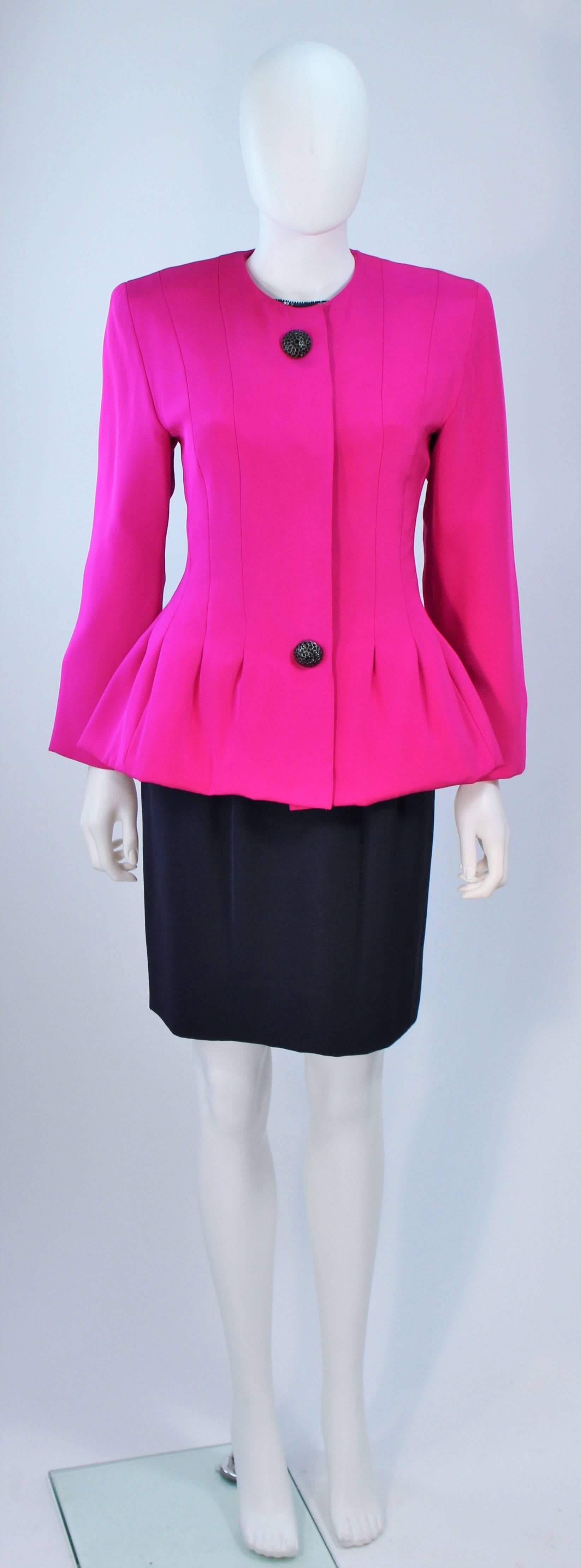  This Jacqueline De Ribes  skirt suit is composed of a magenta silk jacket with silk skirt and sequined chiffon blouse. The jacket features a peplum style with large black rhinestone buttons. There is a sequin sleeveless blouse in navy with side and