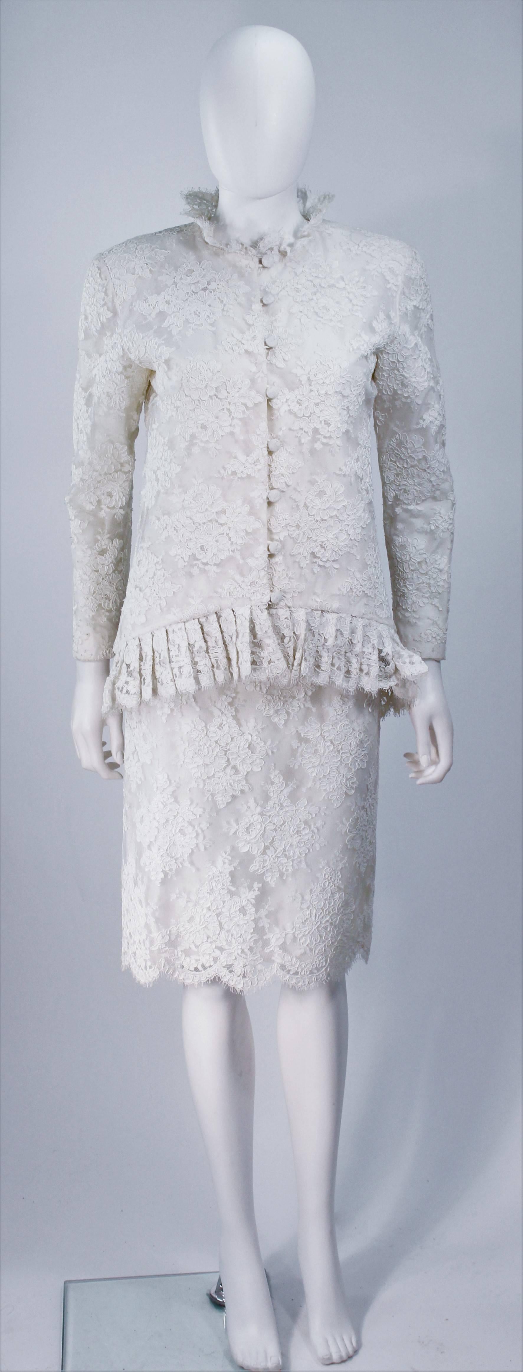  This Bon Choix ensemble is composed of a white lace with scalloped edges. The jacket  features center front button closures with a scalloped edge collar. The skirt has a classic pencil style with zipper closure. In great vintage