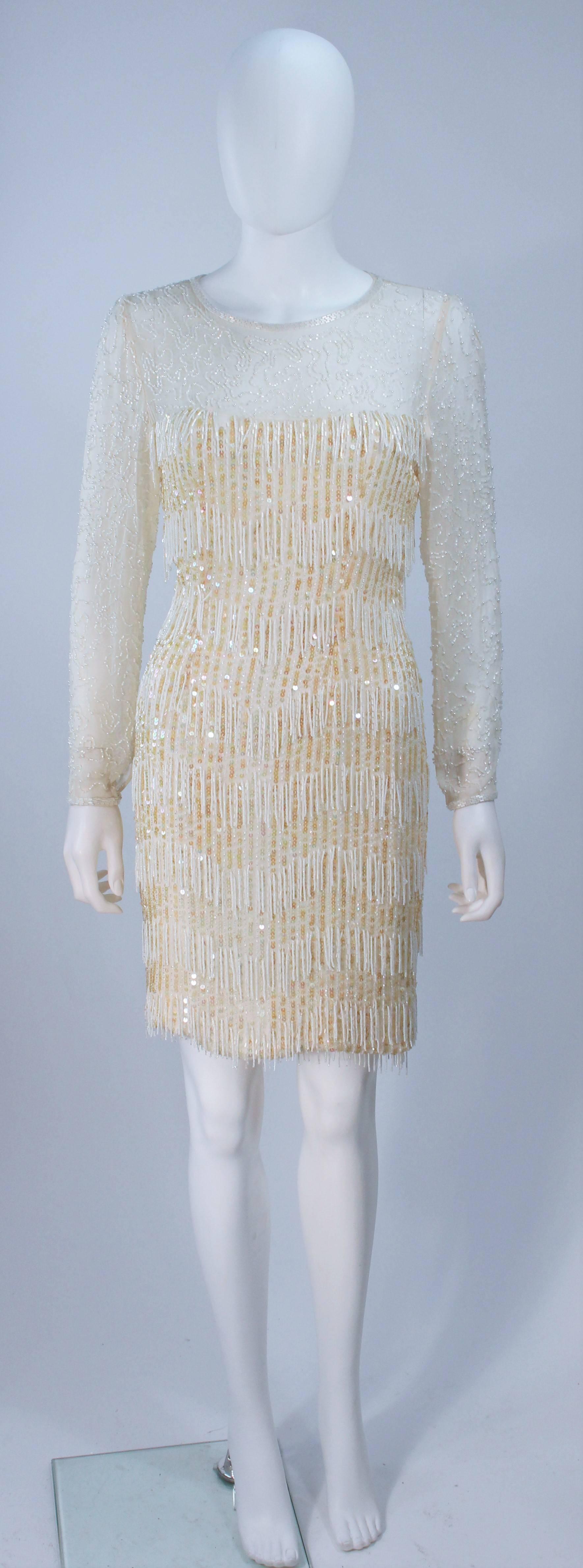  This cocktail dress is composed of a off white and cream combination with iridescent hued sequins and faux pearl bead applique. Features sheer sleeves and bodice.There is a center back zipper closure. In great vintage condition. 

  **Please