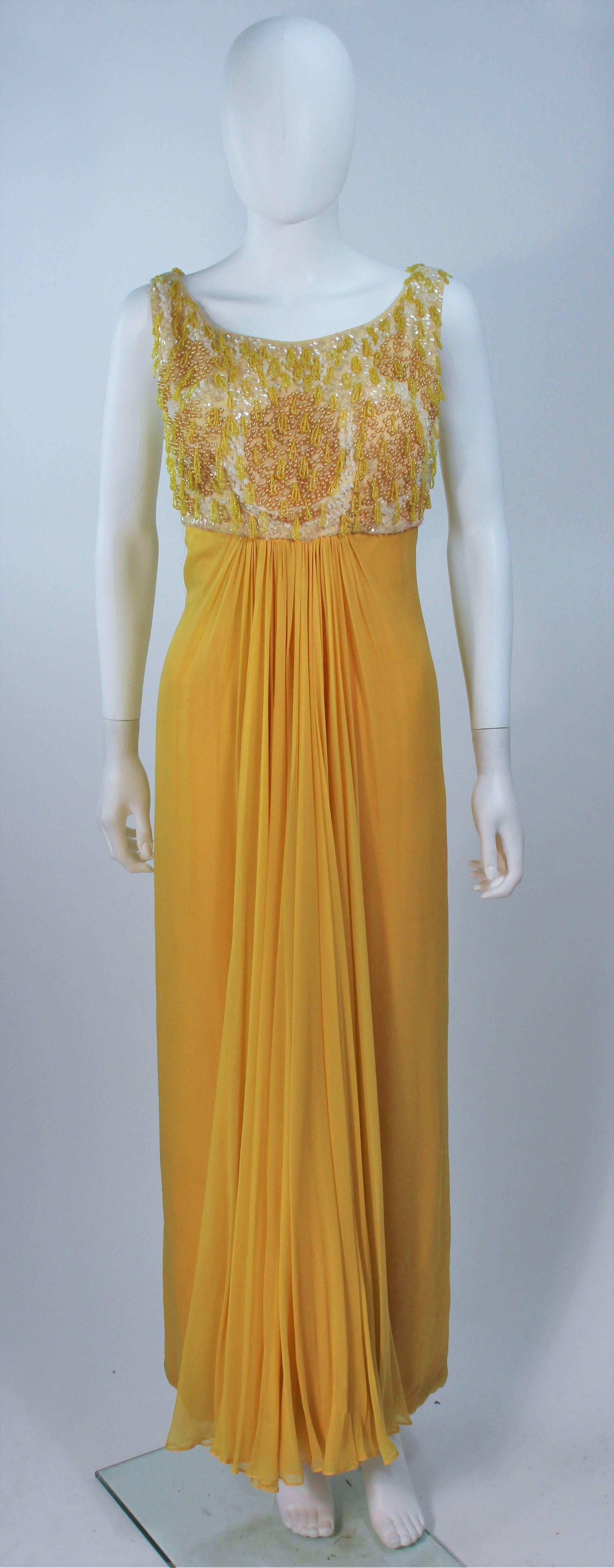  This gown is composed of a yellow chiffon with an embellished bodice. Features a fully boned interior bodice. There is a center back zipper closure. In great vintage condition.

  **Please cross-reference measurements for personal accuracy. Size
