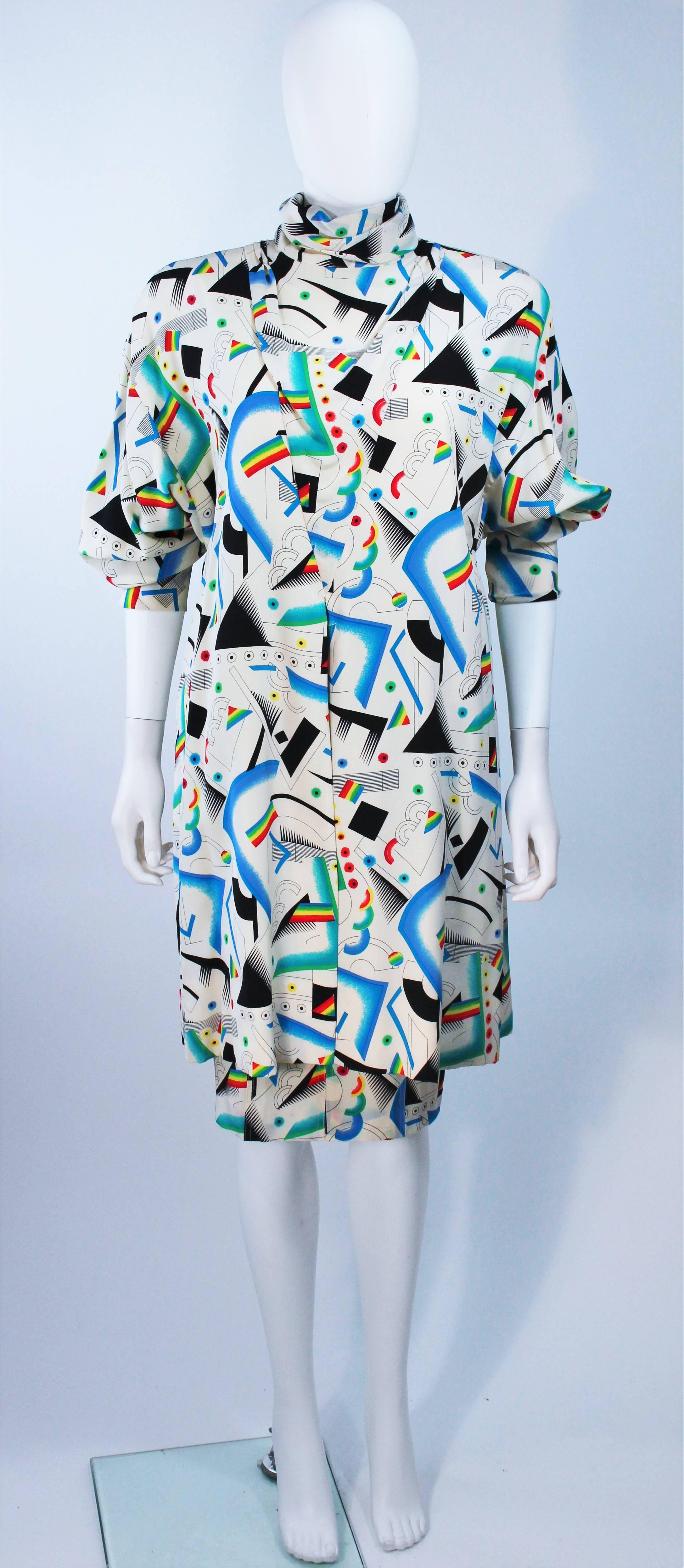  This Fendi ensemble is composed of an off white silk with a rainbow prism pattern throughout. The top is a long tunic style with a center back closure with pleat detail. The pencil style skirt features a zipper closure with front pockets. In