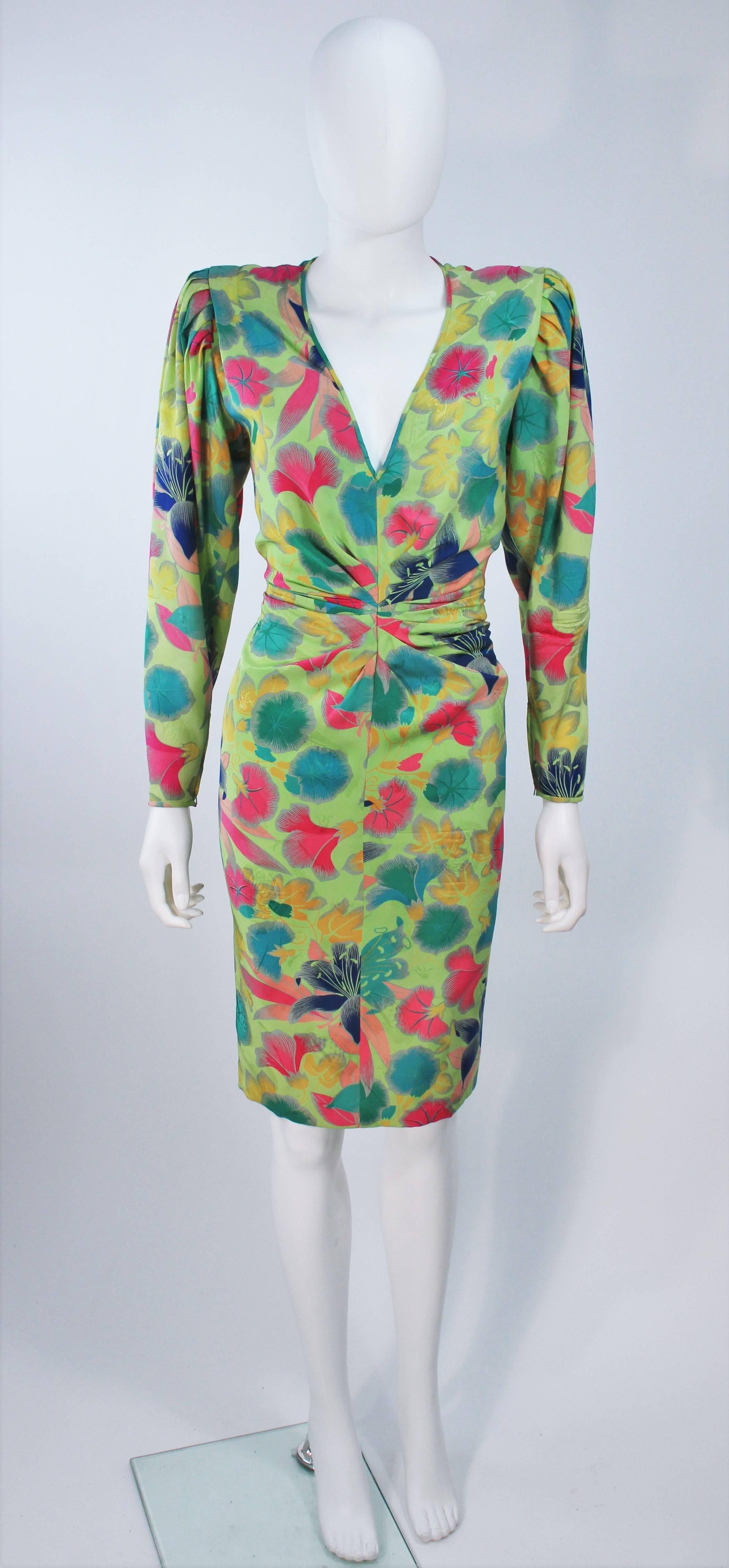  This Emanuel Ungaro dress is composed of a green silk with floral pattern. There is a center front ruched detail, a zipper closure at the center back and sleeves. In excellent vintage condition. 

  **Please cross-reference measurements for