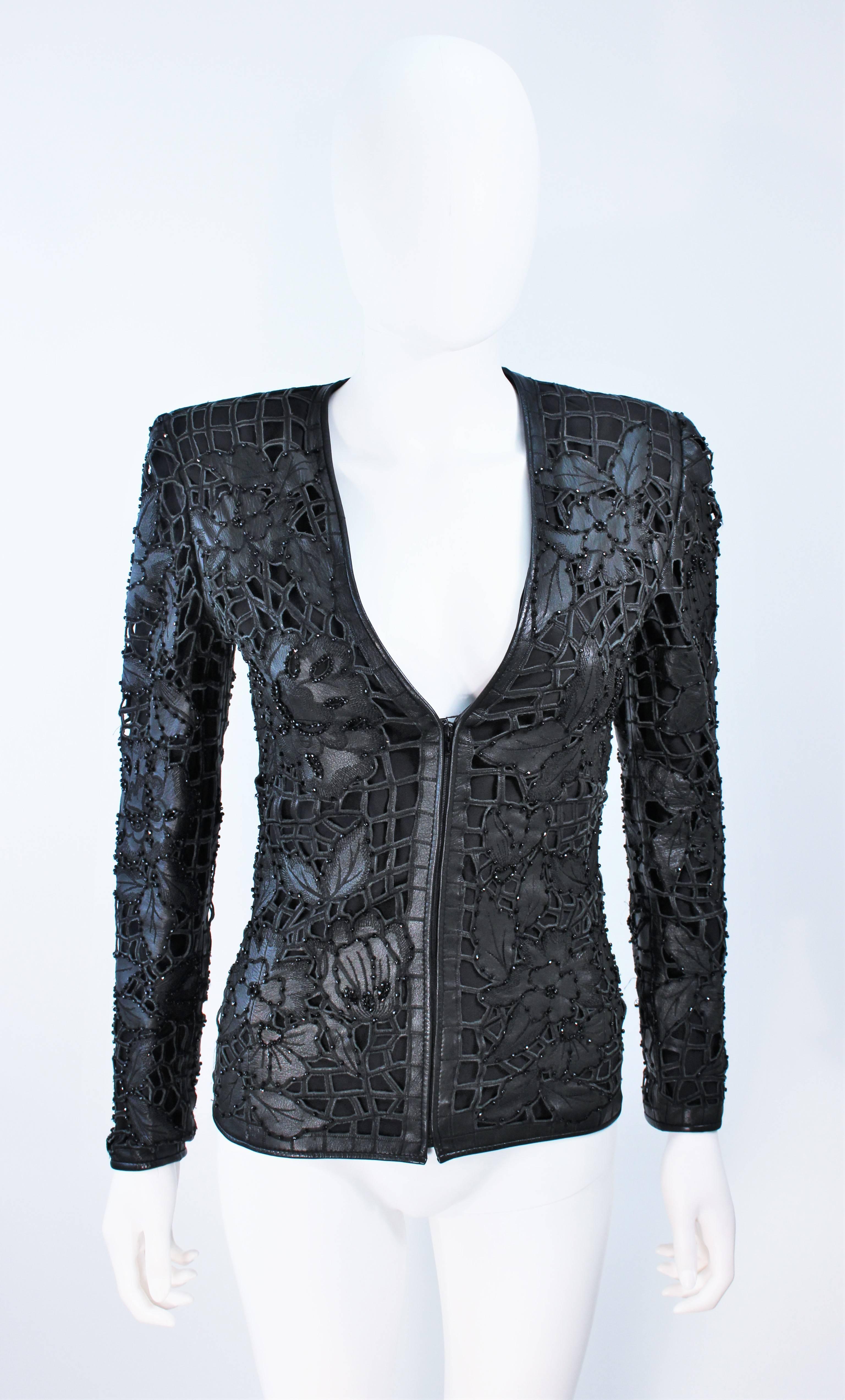  This Valentino jacket is composed of a cut out leather with floral pattern and black faceted bead applique throughout. There is a center front zipper closure. 
In excellent vintage condition. 

  **Please cross-reference measurements for personal