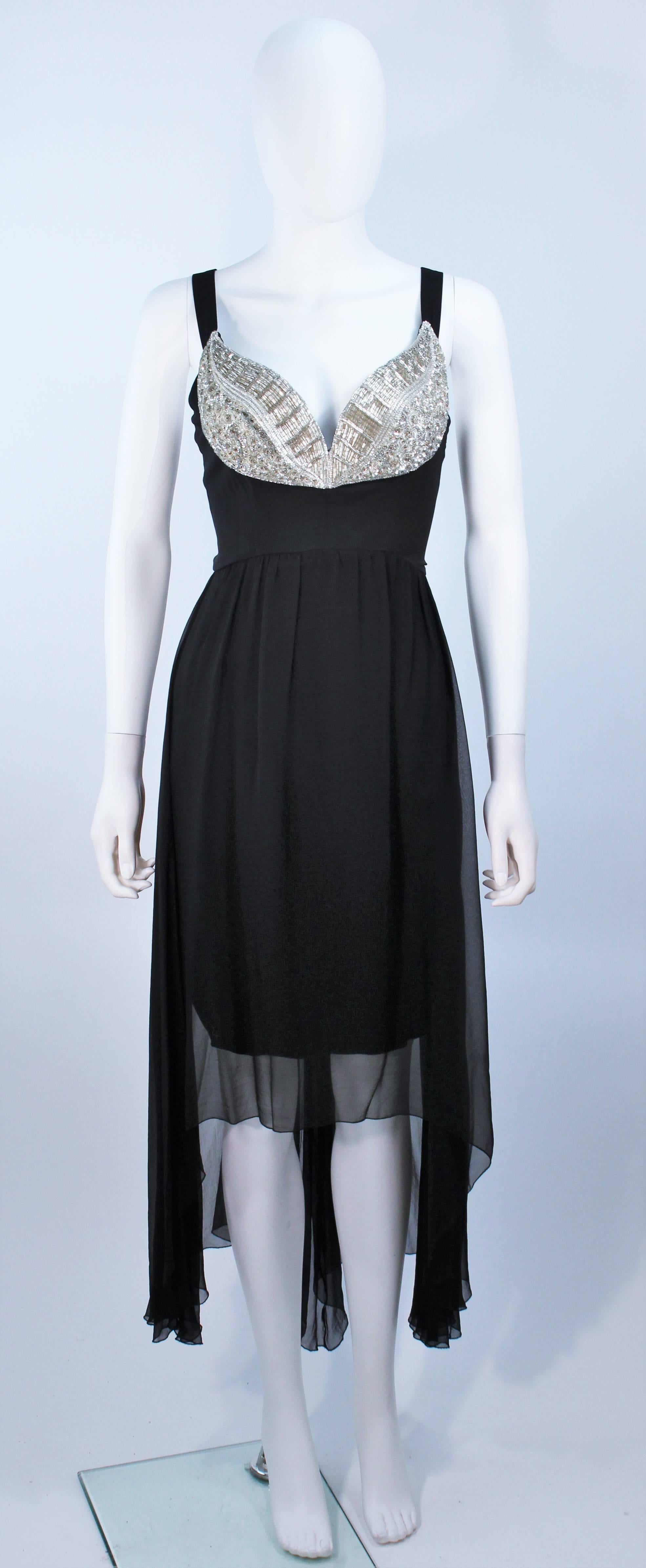  This Karl Lagerfeld  dress is composed of black silk chiffon a top a black stretch silk with an embellished bust applique. There is a center back zipper closure. In excellent vintage condition. 

  **Please cross-reference measurements for