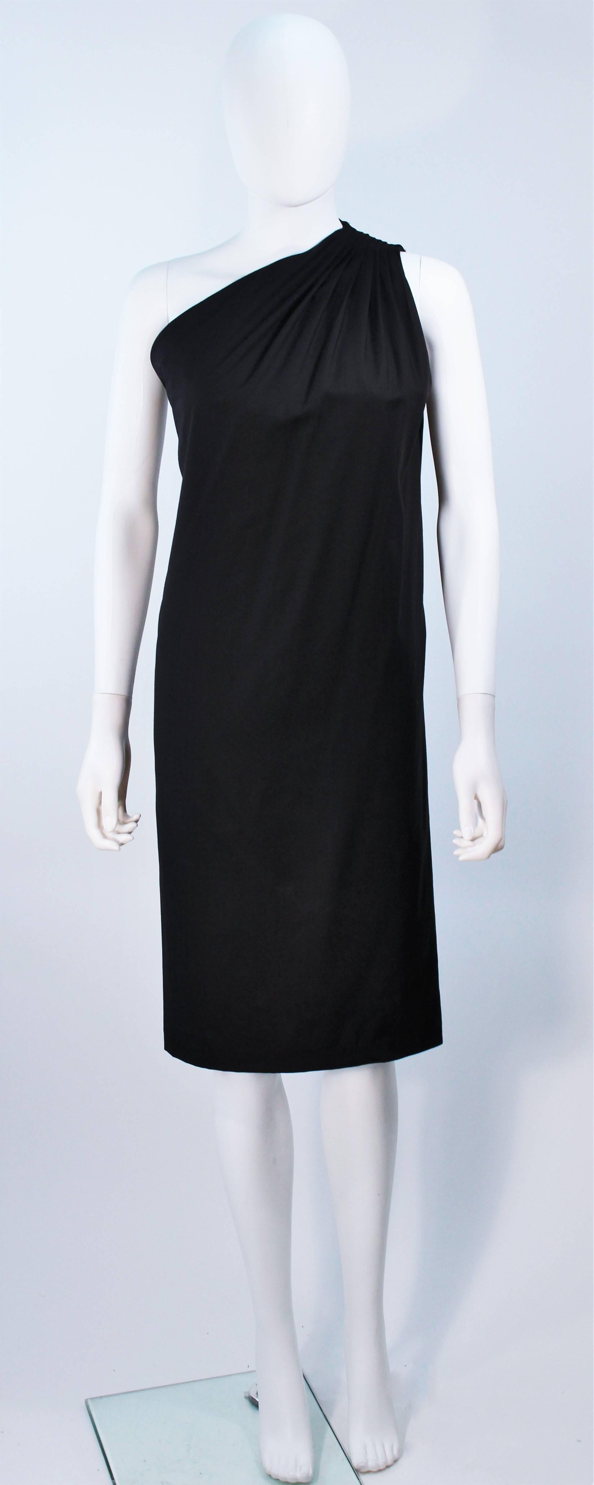  This Halston dress is composed of a black stretch silk and features a one shoulder design with gathers. Pull over style. In excellent condition. 

  **Please cross-reference measurements for personal accuracy. 

Measures