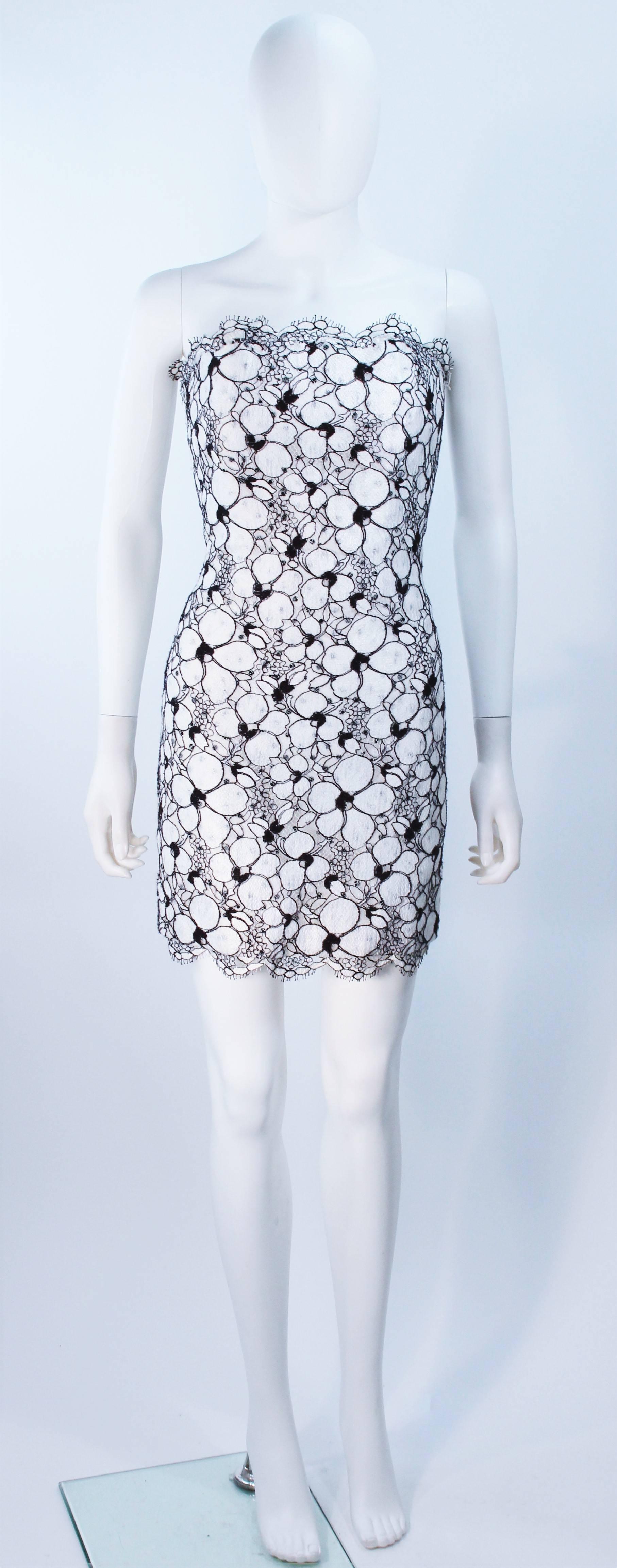  This Fred Hayman dress is composed of a black and white floral fabric with scallop edges. There is a center back zipper closure and interior boning. In excellent vintage condition. 

  **Please cross-reference measurements for personal accuracy.