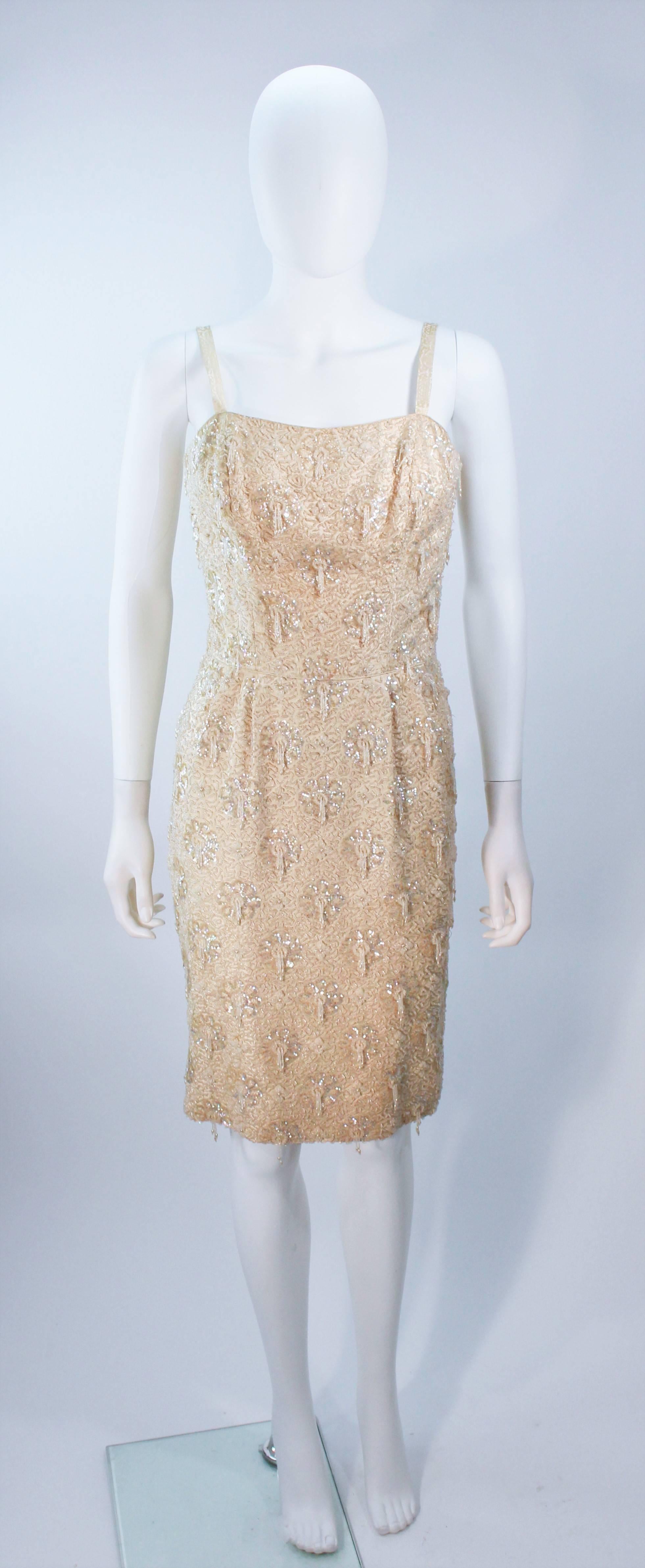 1960s custom cocktail dress 
Cream silk 
Hand beaded and sequined 
Back slit and zipper 
Fully lined 
Personal property of actress Maria Bello 