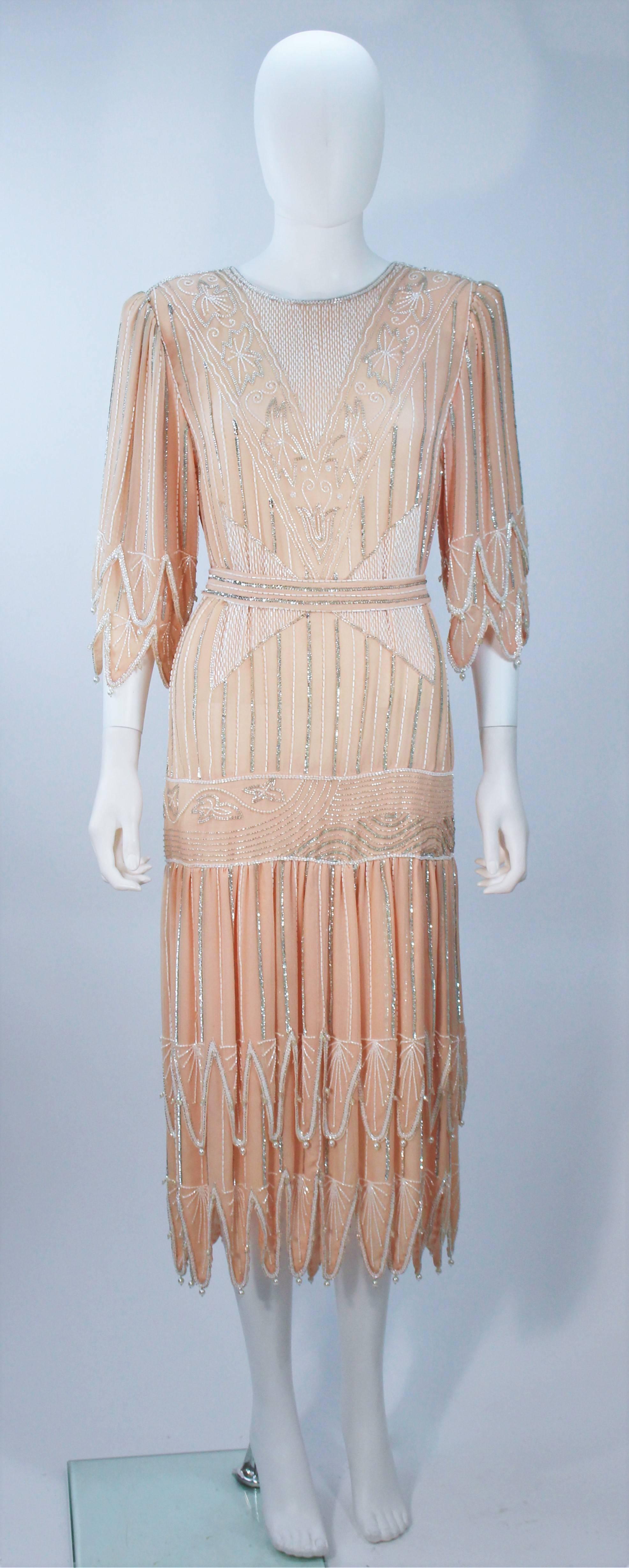 Judith Ann Creations flapper dress  
Peach silk 
Bead and pearl embellishments 
Back velcro closure 
Comes with beaded sequin tie belt 
Size Medium 
Made in India 