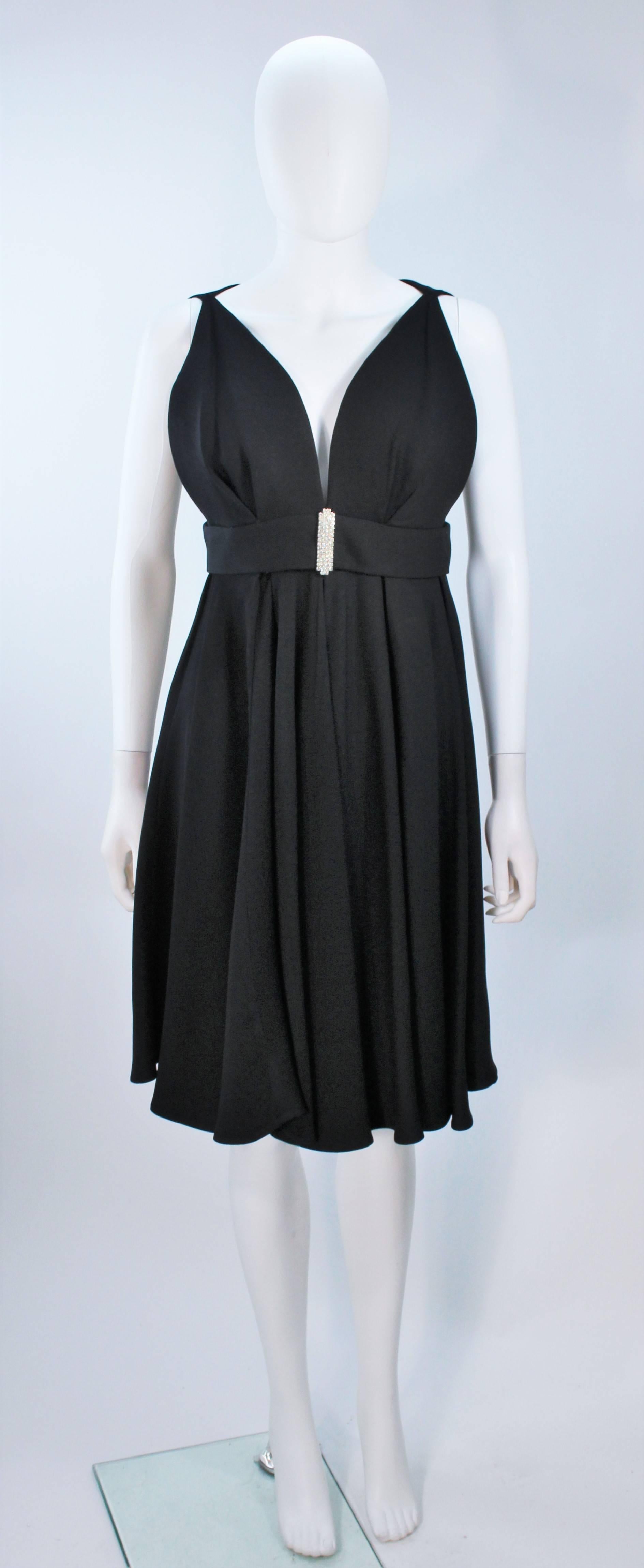  This dress is composed of a black silk crepe and features a center front rhinestone applique. This dress has an amazing design. Center back zipper closure. In excellent vintage condition. 
 
  **Please cross-reference measurements for personal