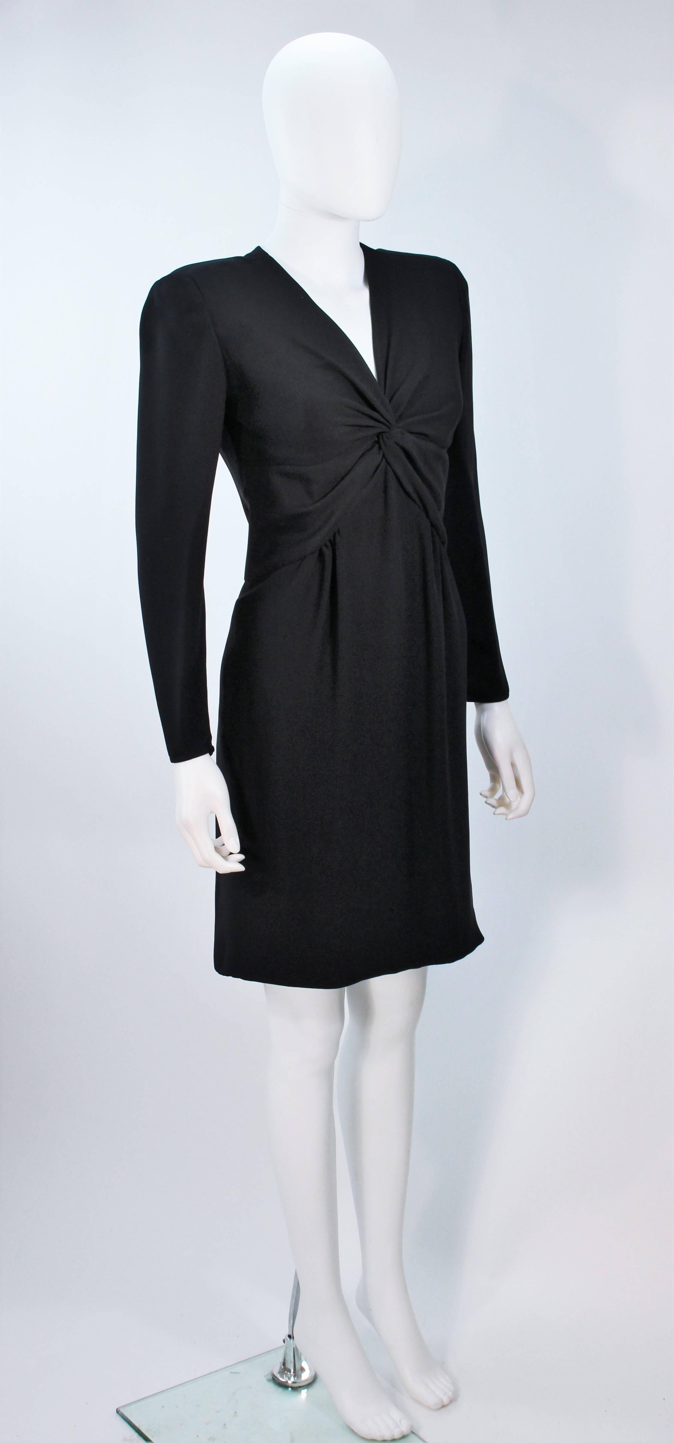  This Valentino dress is composed of a twist front design in black. There is a center back zipper closure. In excellent vintage condition. 

**Please cross-reference measurements for personal accuracy. Size in description box is an