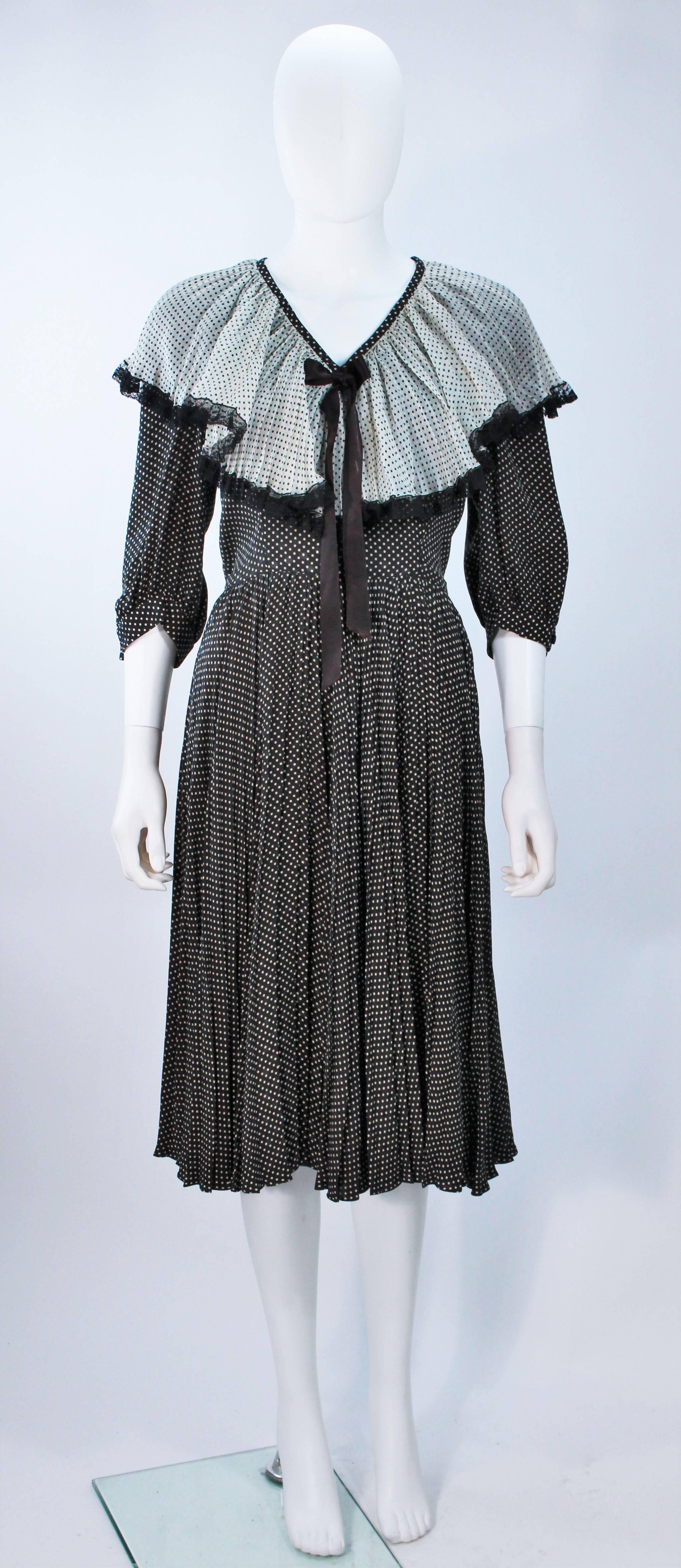  This Valentino attributed design  dress is composed of a pleated polka dot fabric with lace trim. There is a center front satin tie, and side zipper closure. In excellent vintage condition. 

  **Please cross-reference measurements for personal