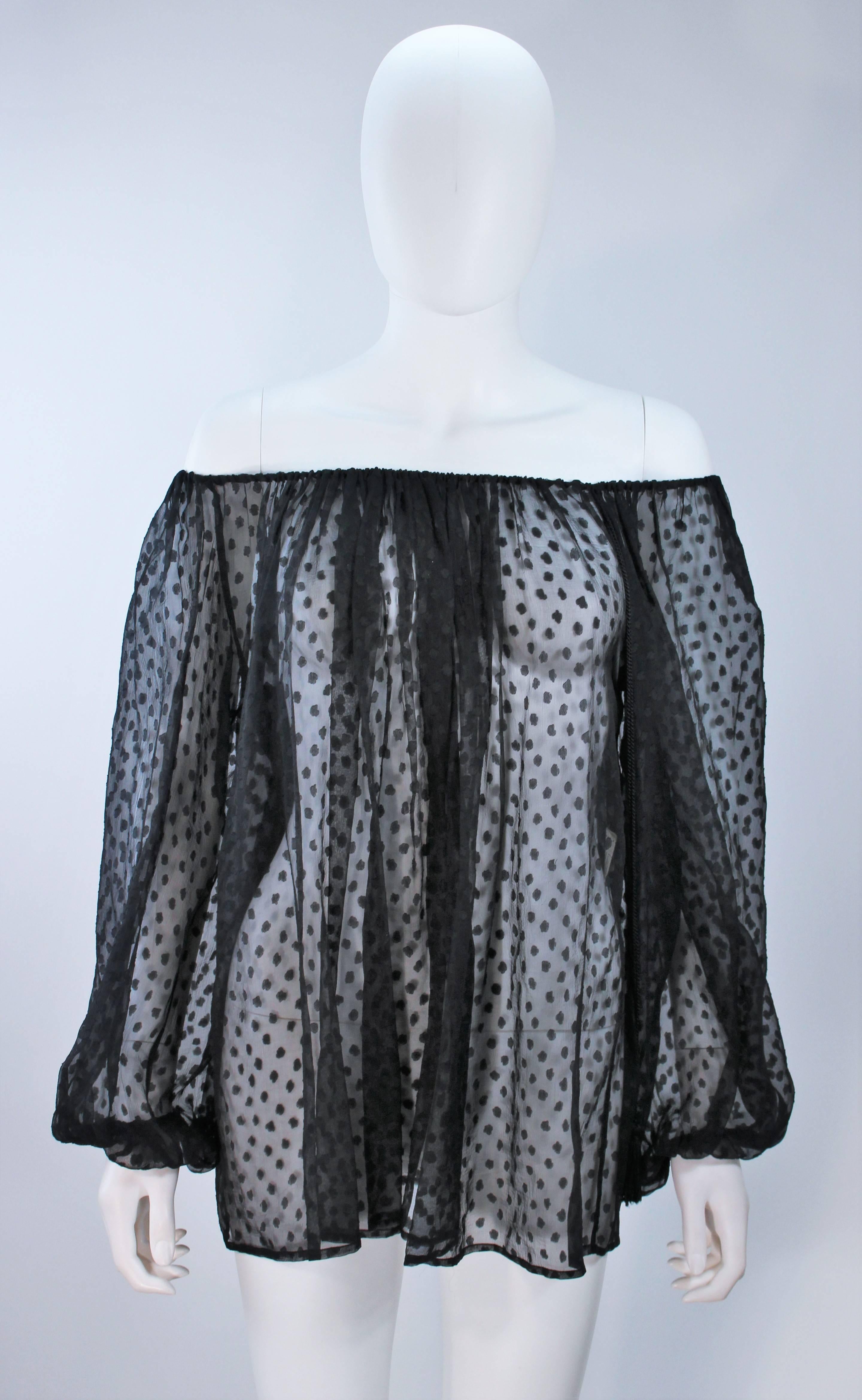  This Yves Saint Laurent blouse is composed of a sheer black polka dot silk. Features a stretch neckline and sleeves. Pull over style with tassel detail. In excellent vintage condition. 

 **Please cross-reference measurements for personal
