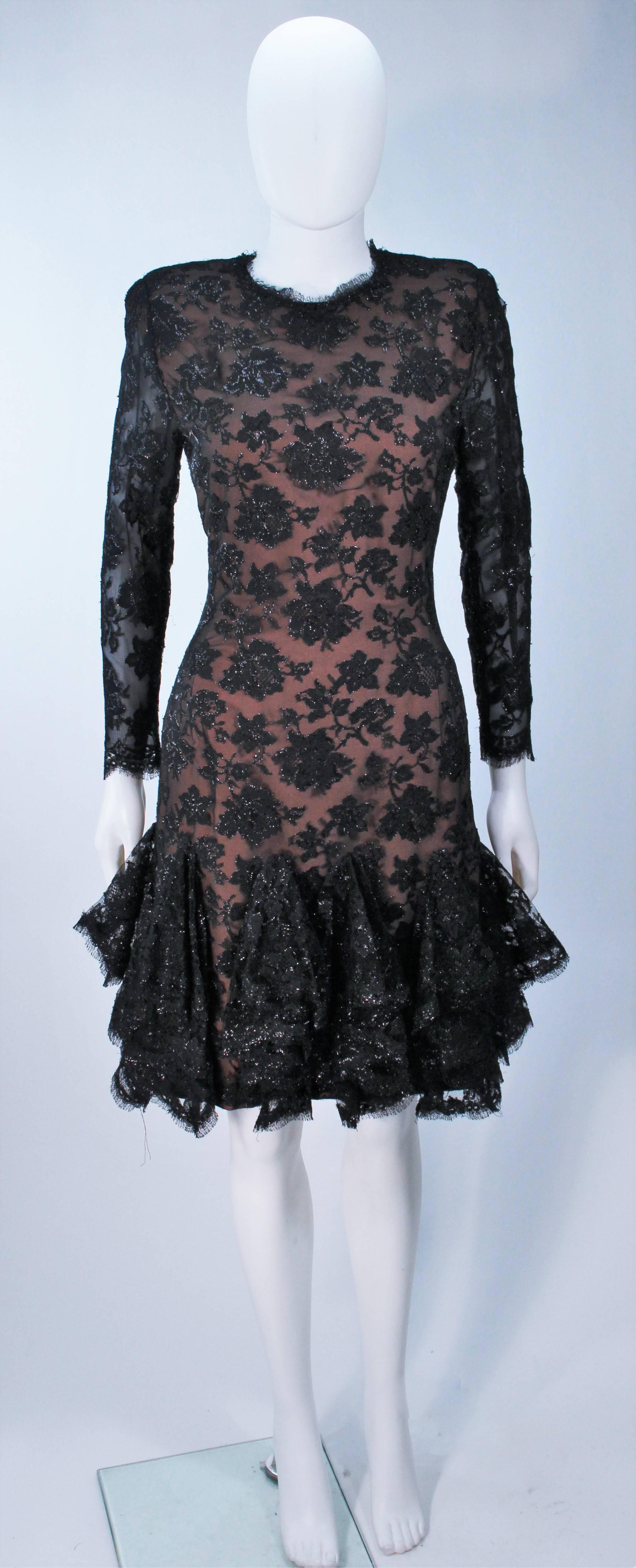  This Travilla  cocktail dress is composed of a black on black metallic silk lace lame with nude underlay. The dress features a draped ruffle hem with scallop edges. There is a center back zipper closure. In excellent vintage condition.

 