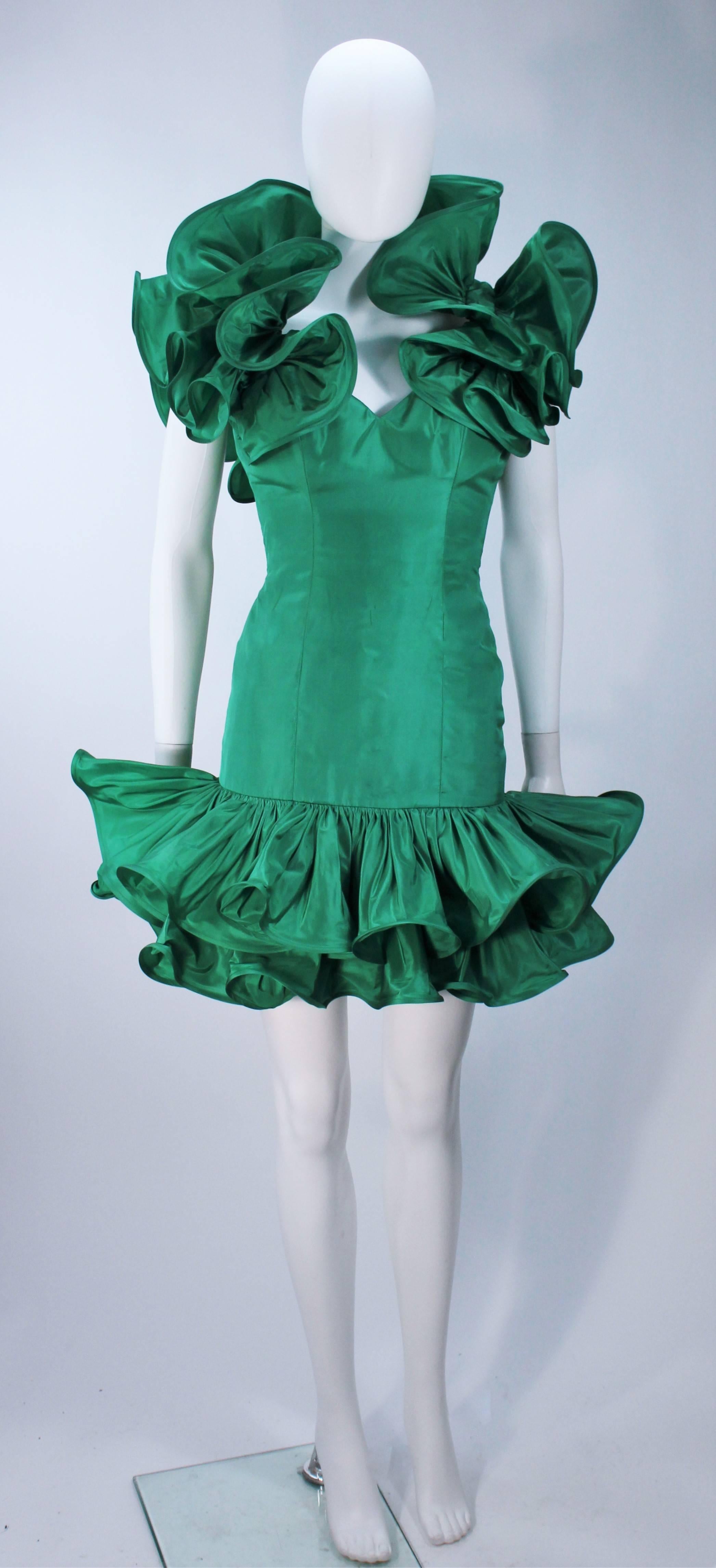  This Travilla attributed design cocktail dress is composed of a kelly green silk and features a ruffled trim with horse hair for structure. There is a zipper closure. In excellent vintage condition. 

  **Please cross-reference measurements for