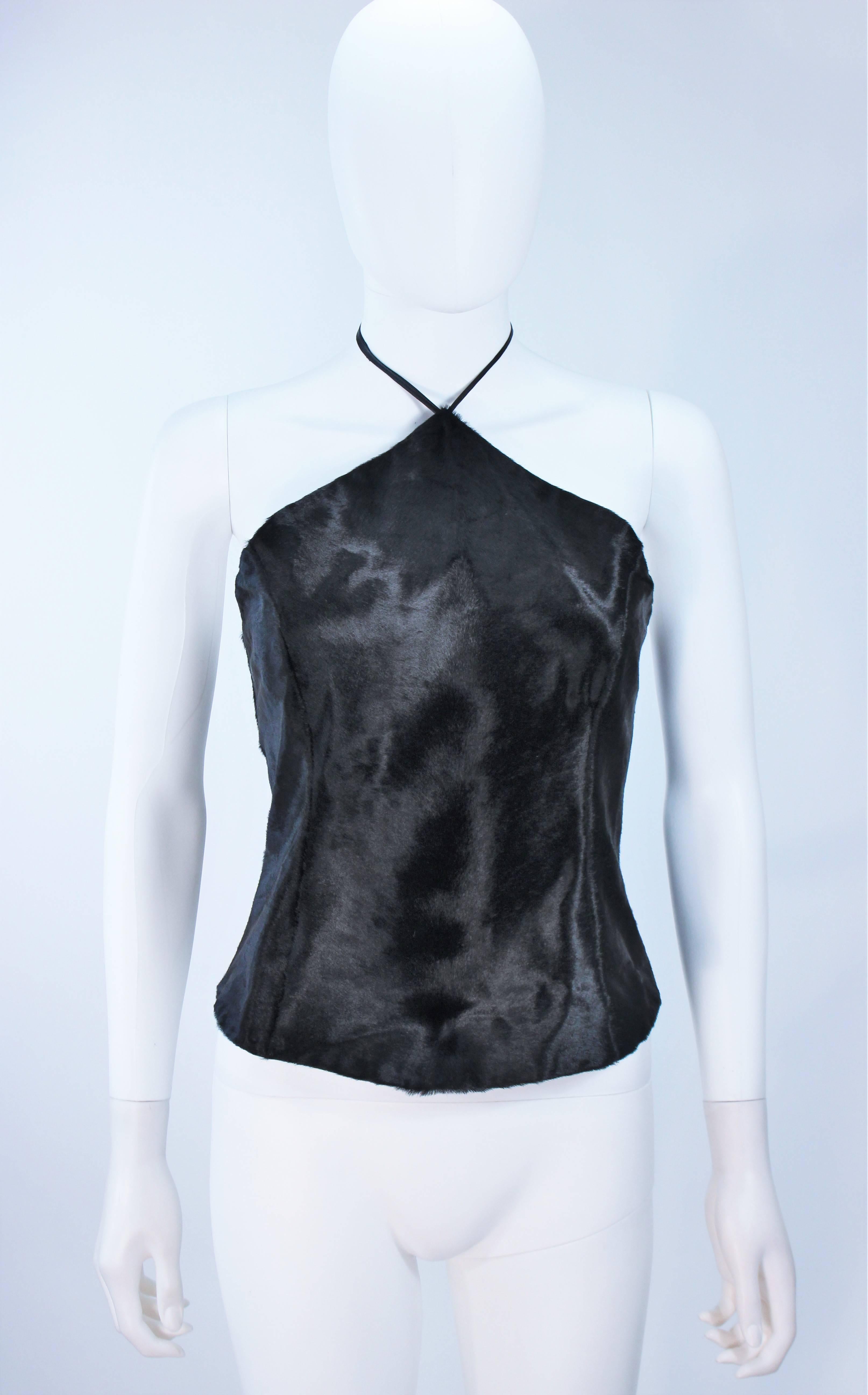  This Vera Wang  top is composed of a striking black cowhide and features leather tie accents. There is a center back zipper closure. In excellent vintage condition with original tags.
 
  **Please cross-reference measurements for personal