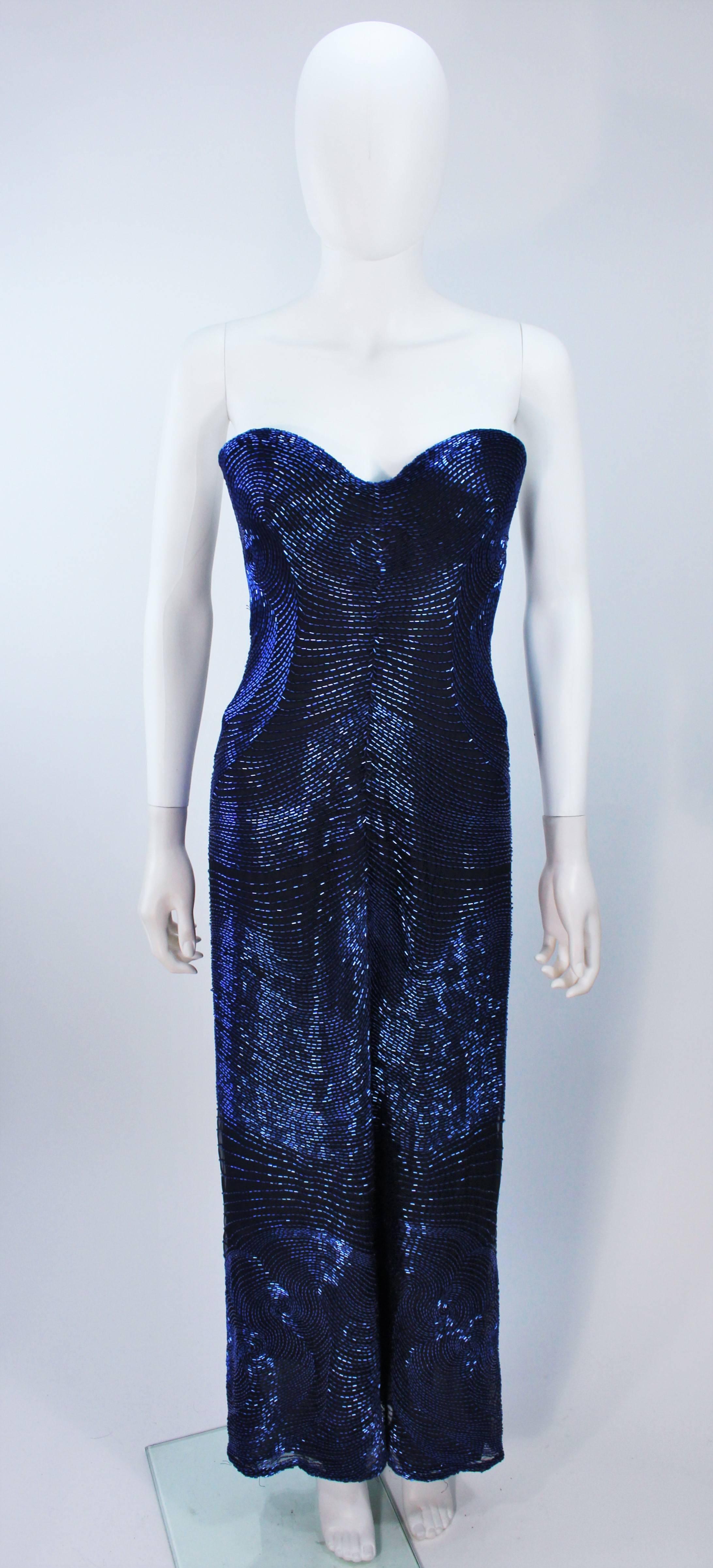  This Halston dress is composed of a beautifully beaded black silk with cobalt blue beading. The strapless style features sweetheart neckline with a center front slit. There is a center back zipper closure, and interior boned bustier foundation. In