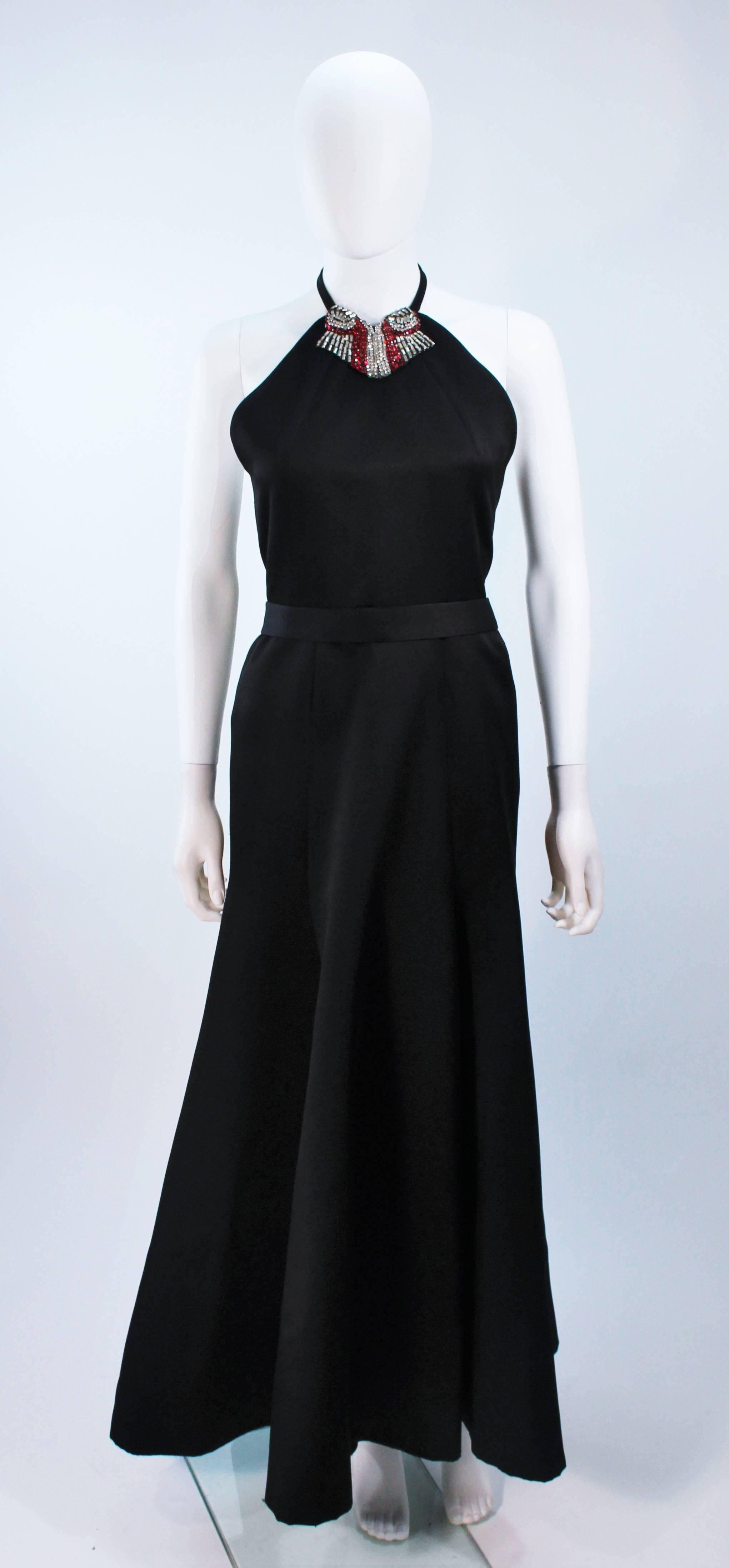  This Chloe  halter style gown is composed of a black satin silk, with a white and red rhinestone collar. There is a center back zipper closure and belt. In excellent vintage condition. 

  **Please cross-reference measurements for personal