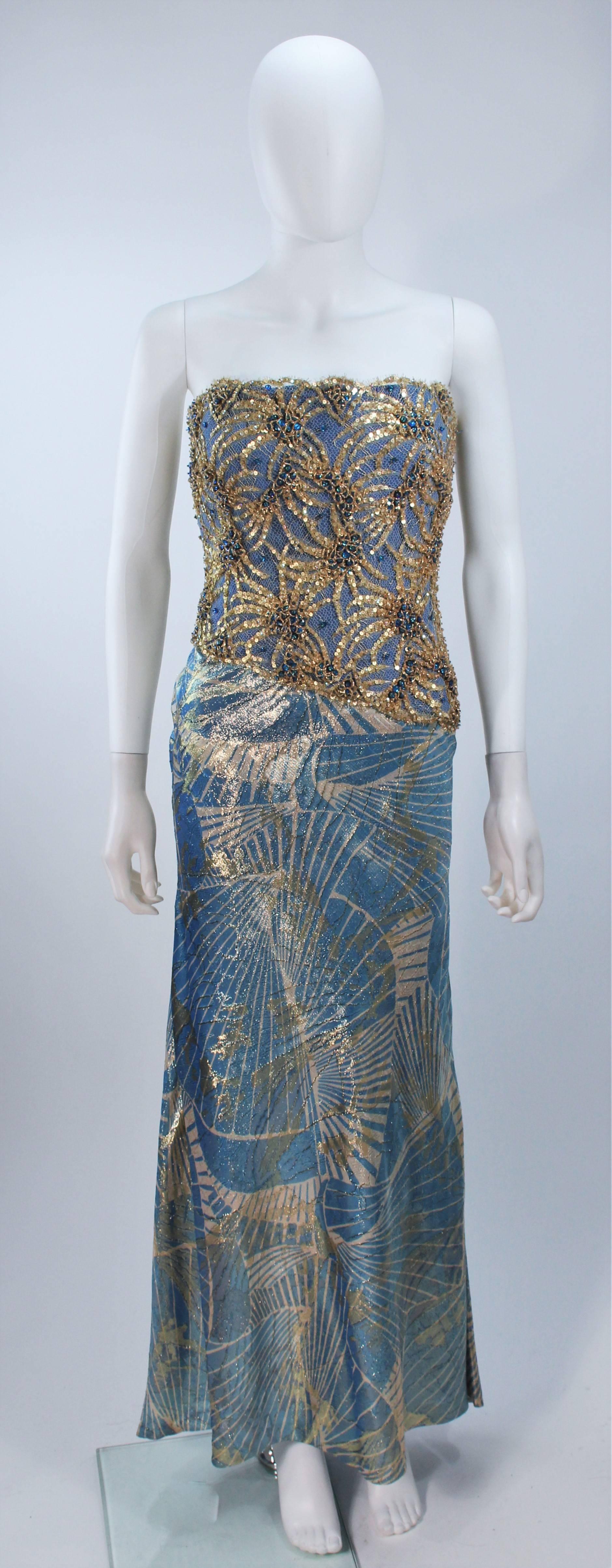  This Galanos  gown is composed of a baby blue and gold embellished silk lame. The bodice features beading and sequin embellishments. Features an interior boned foundation with side zipper, and draped style skirt. In excellent vintage condition.