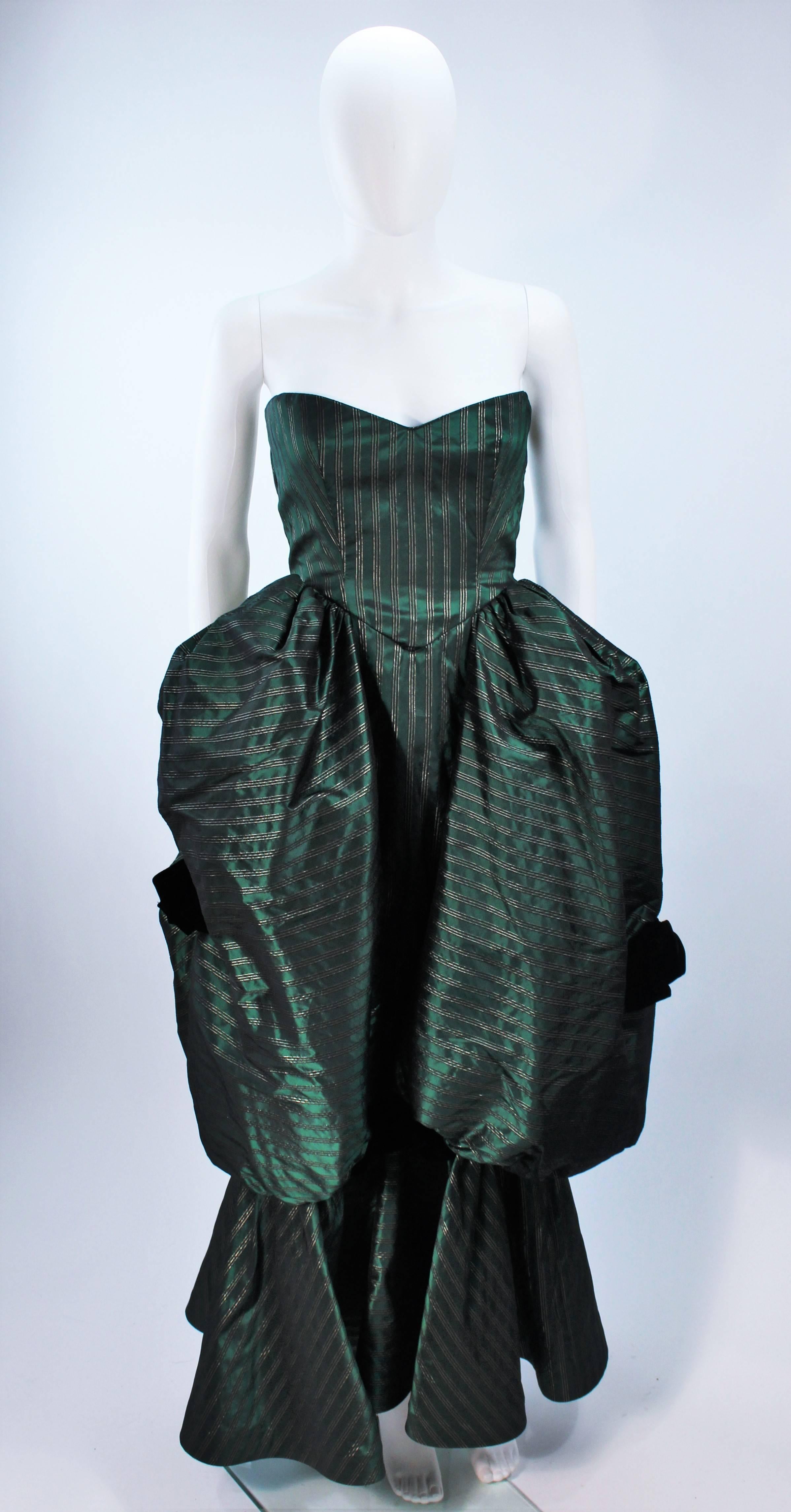 This Michael Novarese  gown is composed of a green striped satin with gold accenting. Features a sweetheart neckline, structured side poufs, and velvet bows. There is a center back zipper closure. In excellent vintage condition. 

  **Please