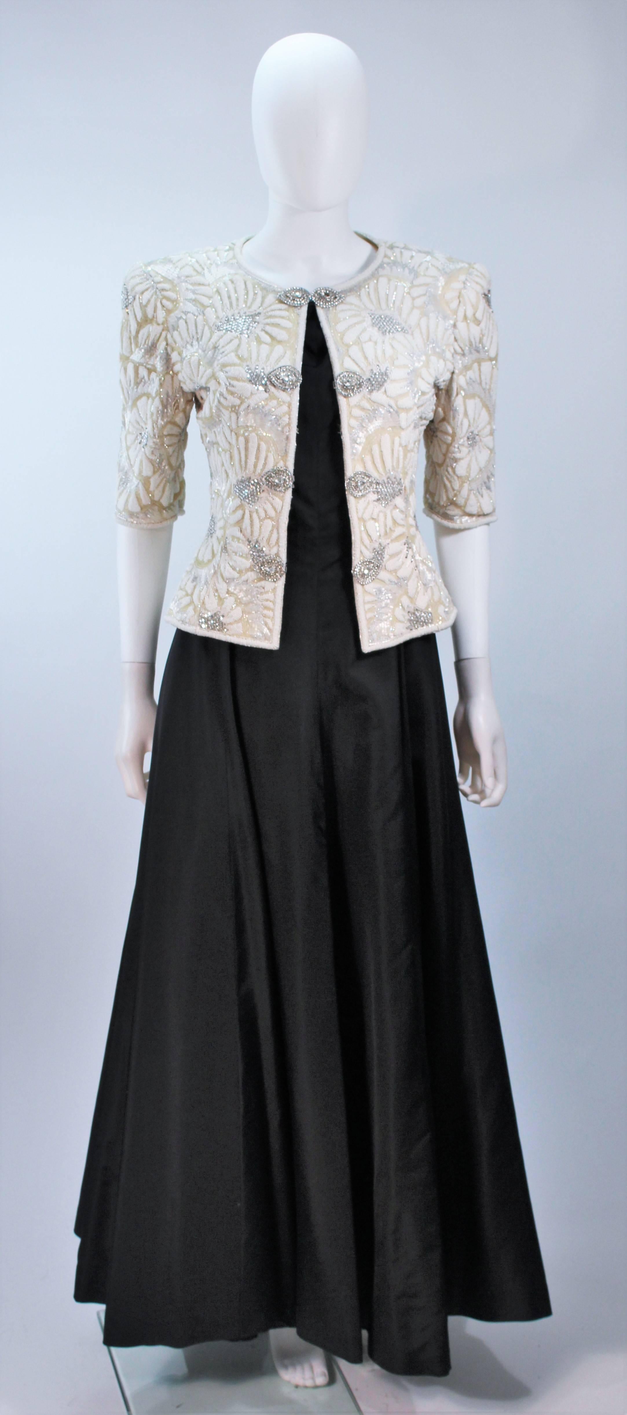  This Oscar de La Renta ensemble features a black satin gown and off white embellished jacket.  The gown features a zipper closure and the jacket has center front closures. In excellent vintage condition. 

  **Please cross-reference measurements