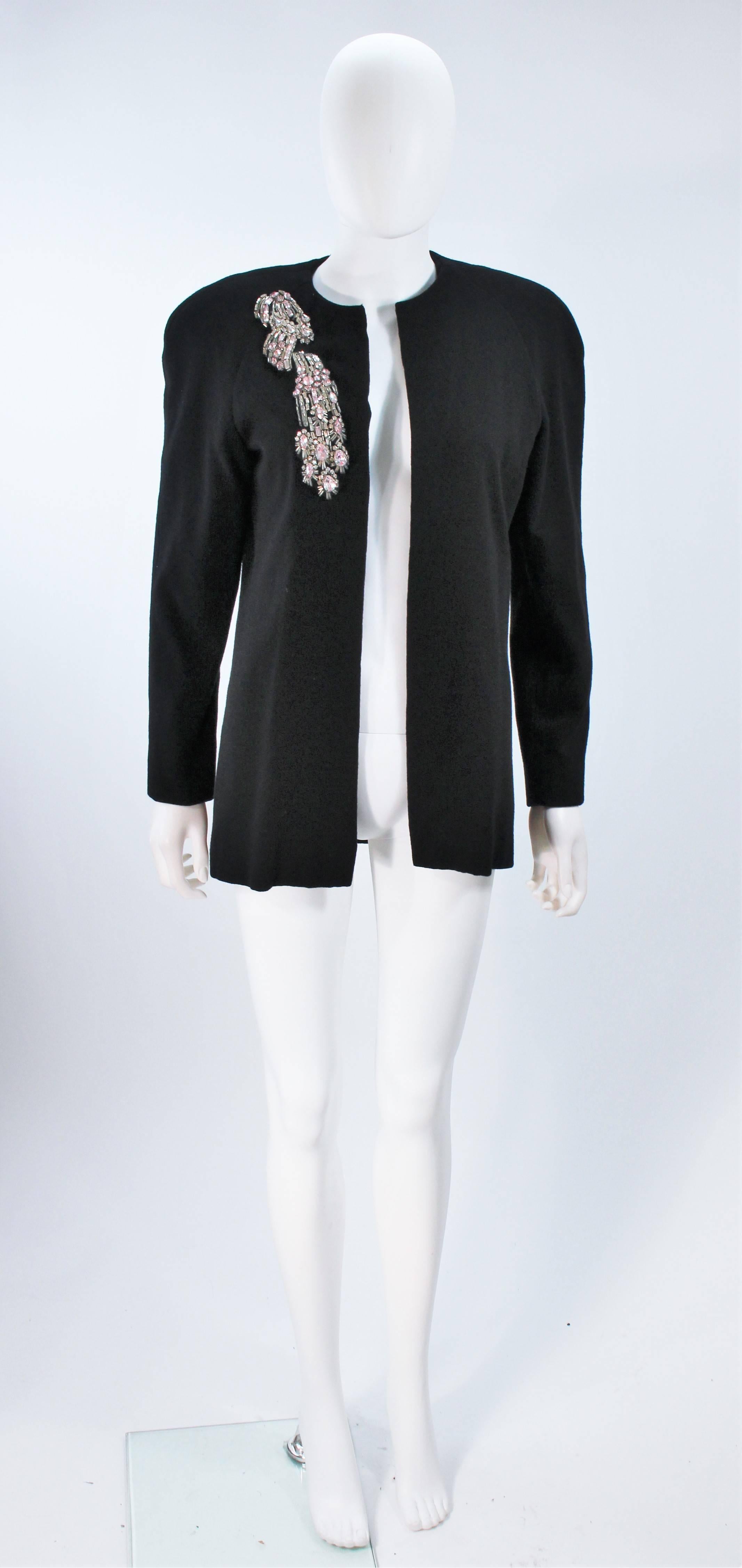  This Carolyn Roehm jacket is composed of a black stretch wool with a white and pink rhinestone applique. Features an open style front. In excellent vintage condition. 

  **Please cross-reference measurements for personal accuracy. Size in