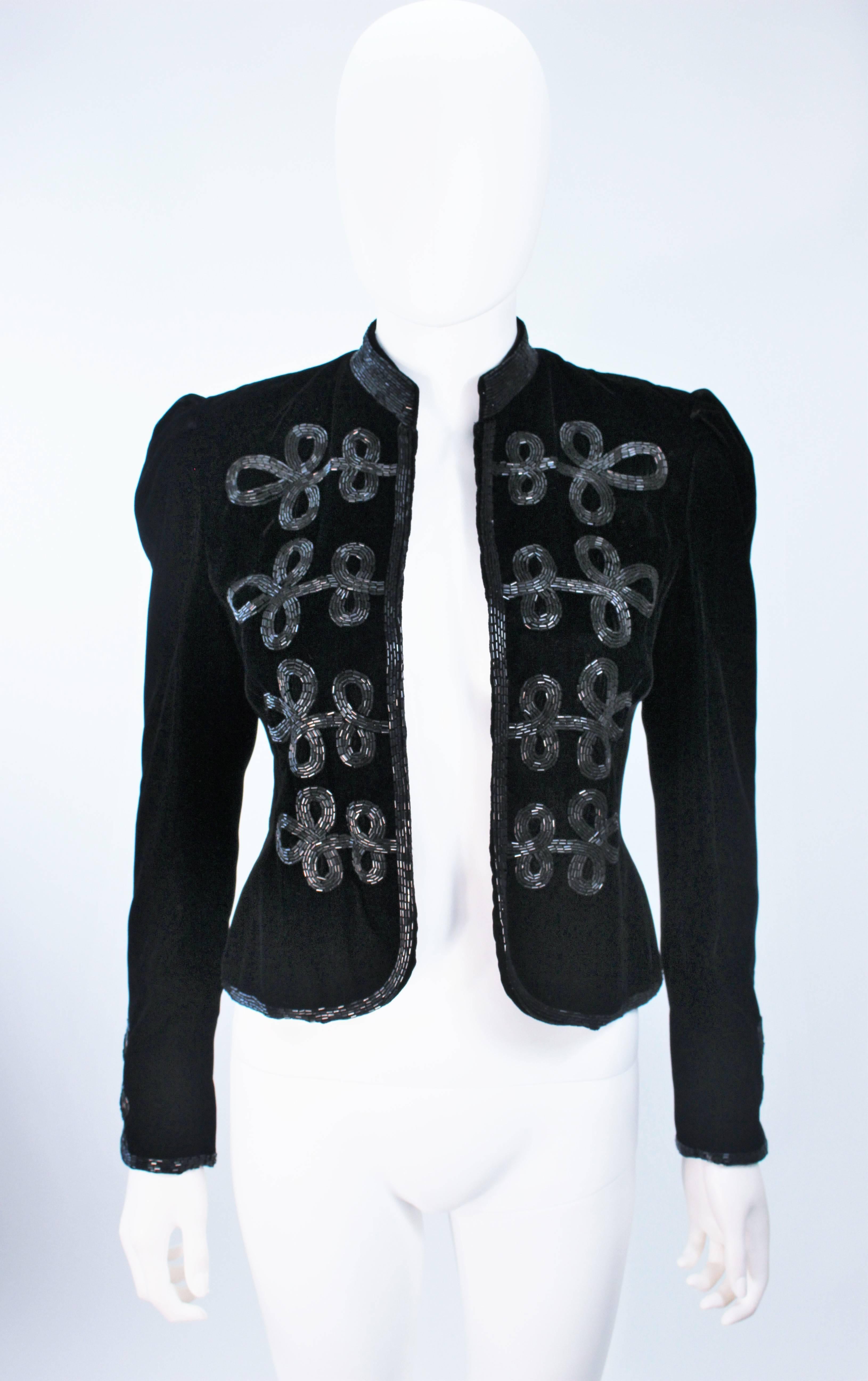  This Oscar De La Renta jacket is composed of a black velvet with black beading. Features a classic mandarin collar, open style front, and puff styled sleeve. In excellent vintage condition. 

  **Please cross-reference measurements for personal