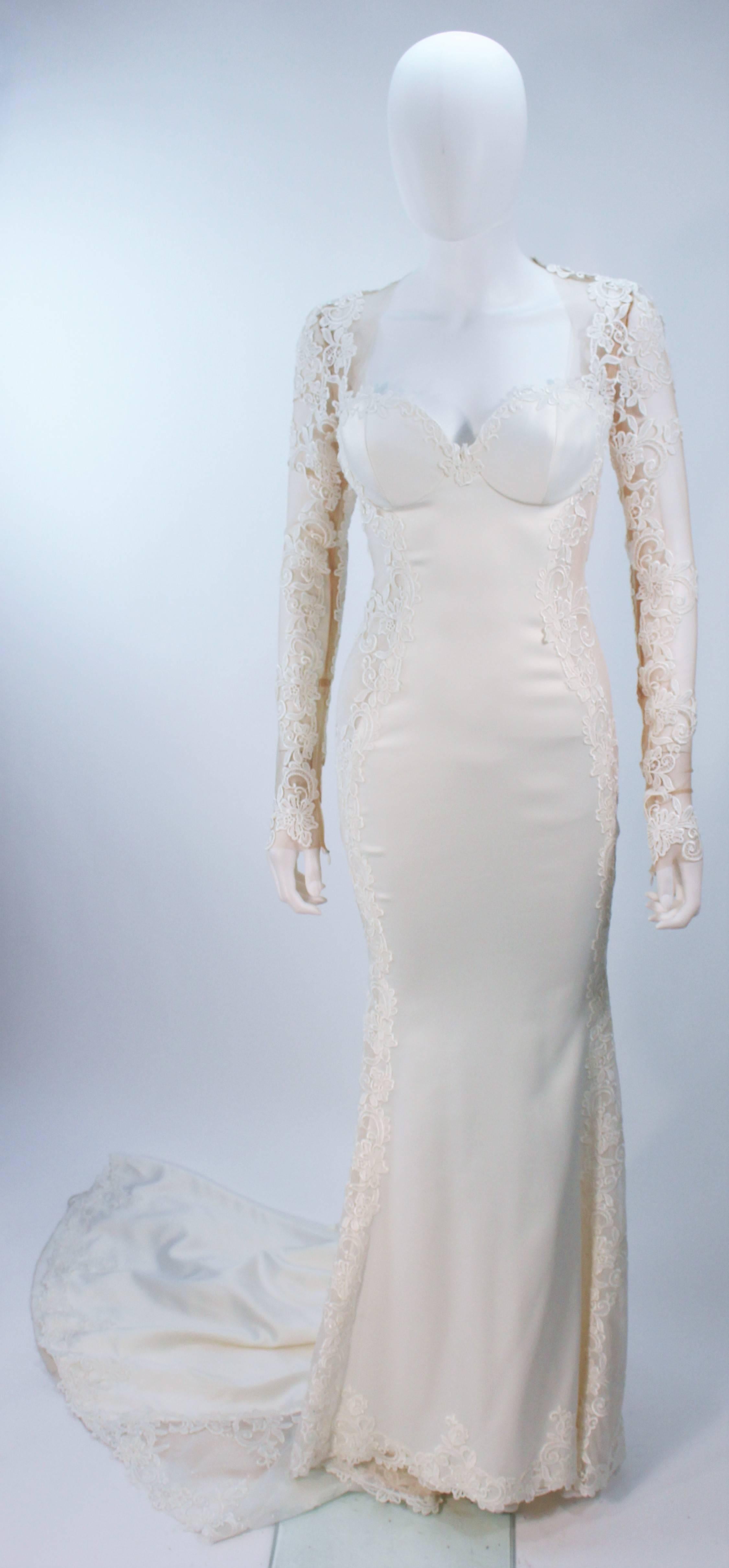  This Galia Lahav  gown is composed of a thick cream jersey with floral applique and sheer details. Features structured cups, and a side zip closure with snaps. An absolutely stunning design. In excellent vintage condition. 

  **Please