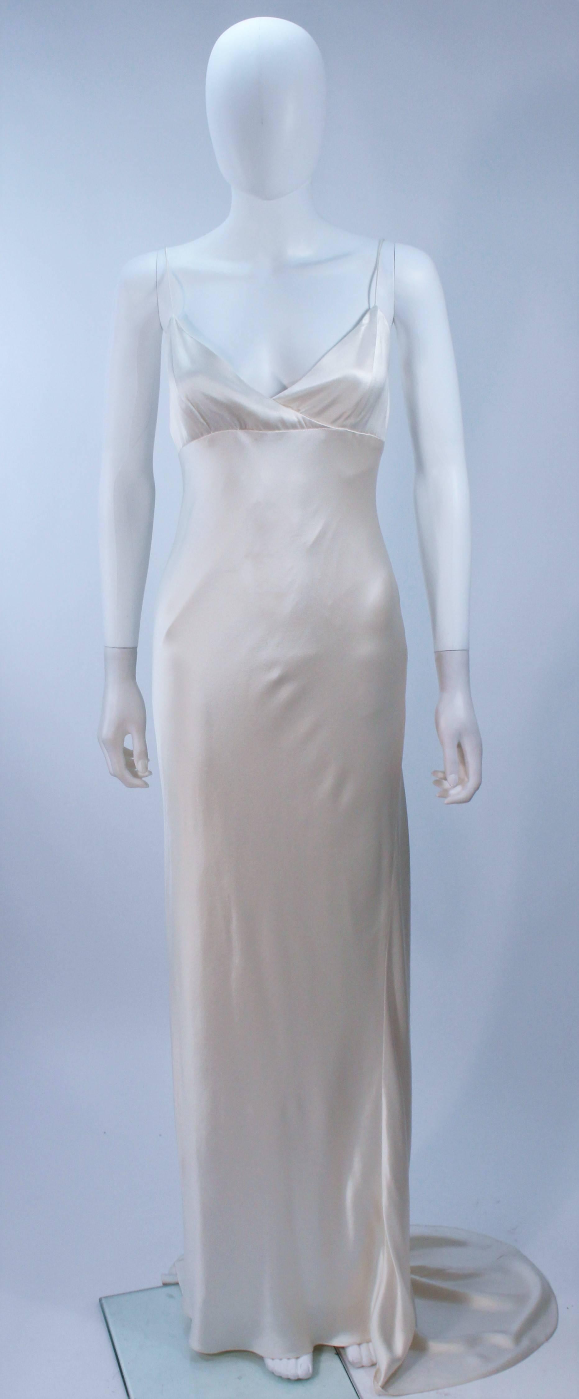  This Monique Lhuillier  gown is composed of a bias cut silk with spaghetti straps. It is pull over style. In excellent pre-owned condition. 

  **Please cross-reference measurements for personal accuracy. Size in description box is an