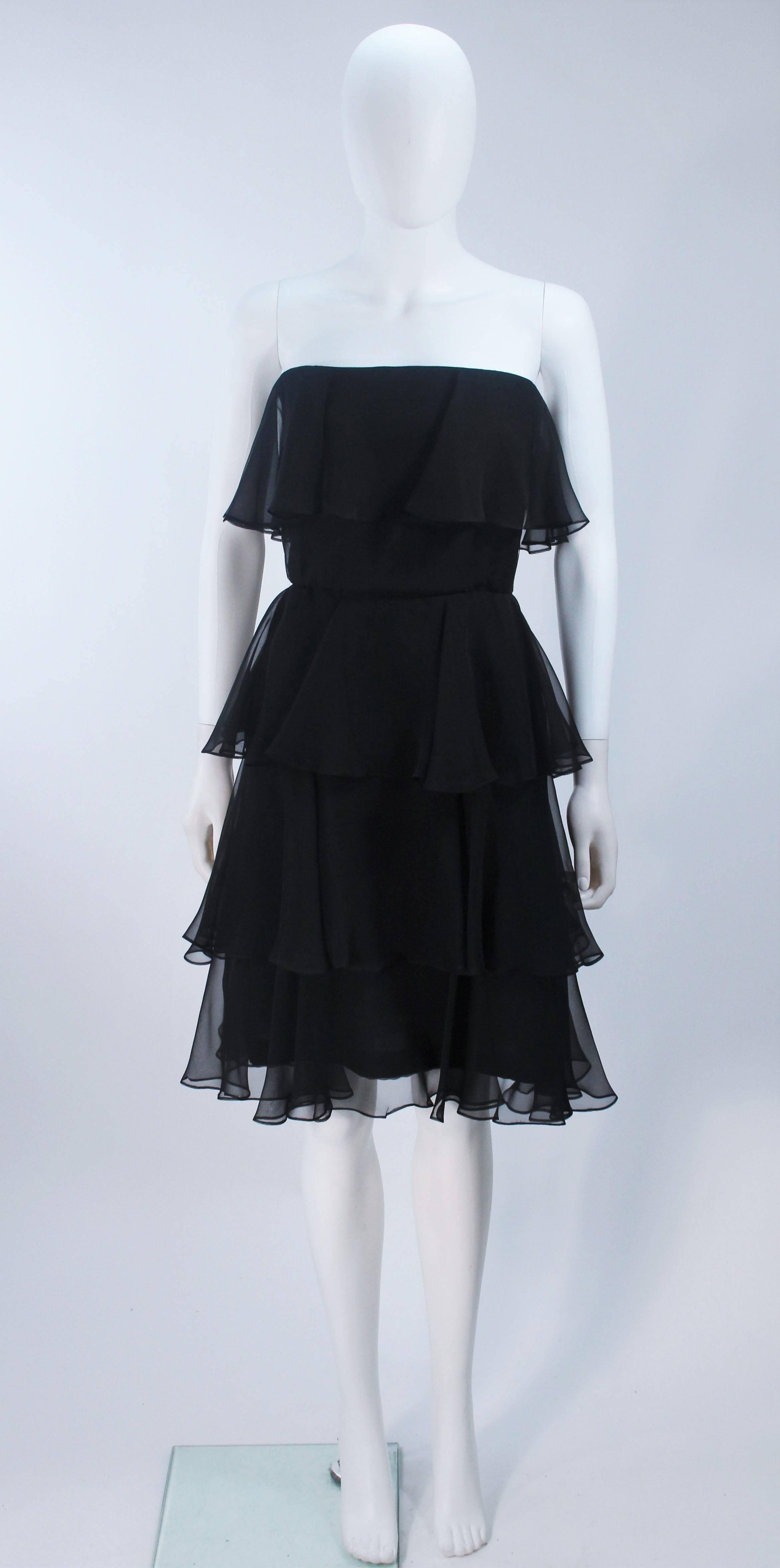  This Estevez  dress is composed of a Tiered black silk chiffon. There is a center back zipper closure. In excellent vintage condition. 

  **Please cross-reference measurements for personal accuracy. Size in description box is an