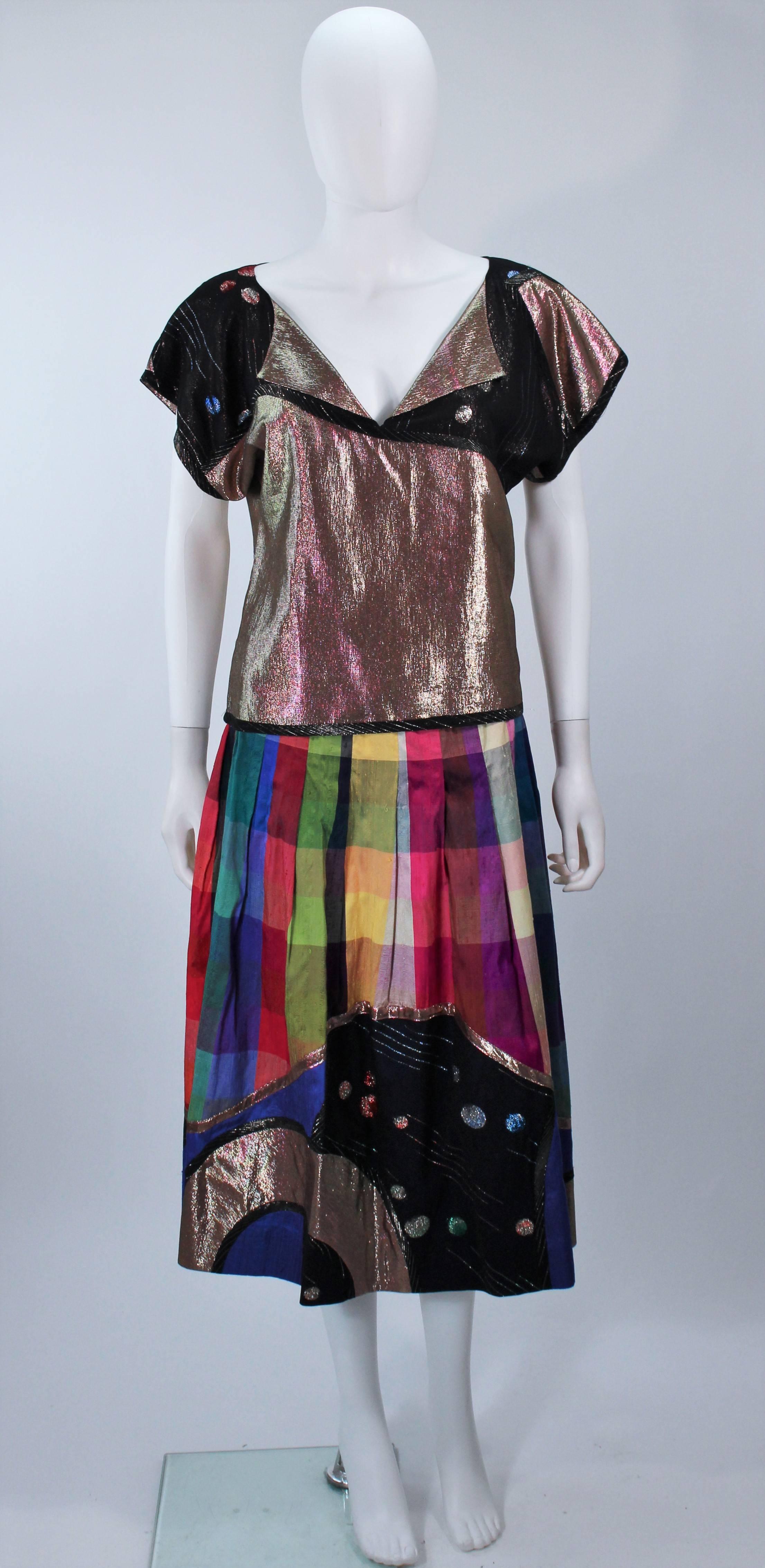  This Koos skirt suit set is composed of silk in metallic hues as well as vibrant plaid print. The blouse and skirt are both pullover style. The skirt features a pleated design. In excellent vintage condition. 

  **Please cross-reference