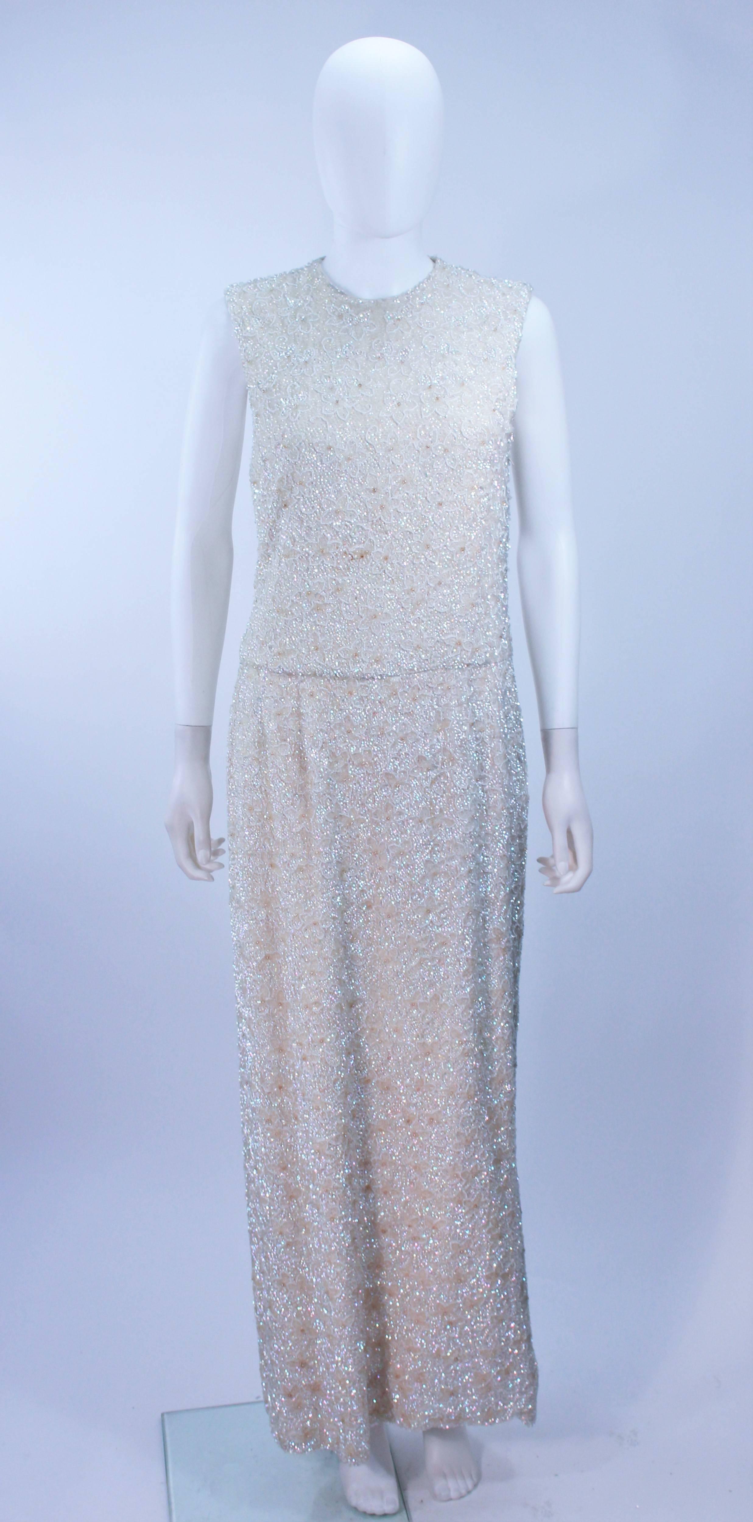  This dress is composed of a embellished silk with iridescent beading and sequins in a floral pattern. There is a center back zipper closure. In excellent vintage condition. 

  **Please cross-reference measurements for personal accuracy. Size in