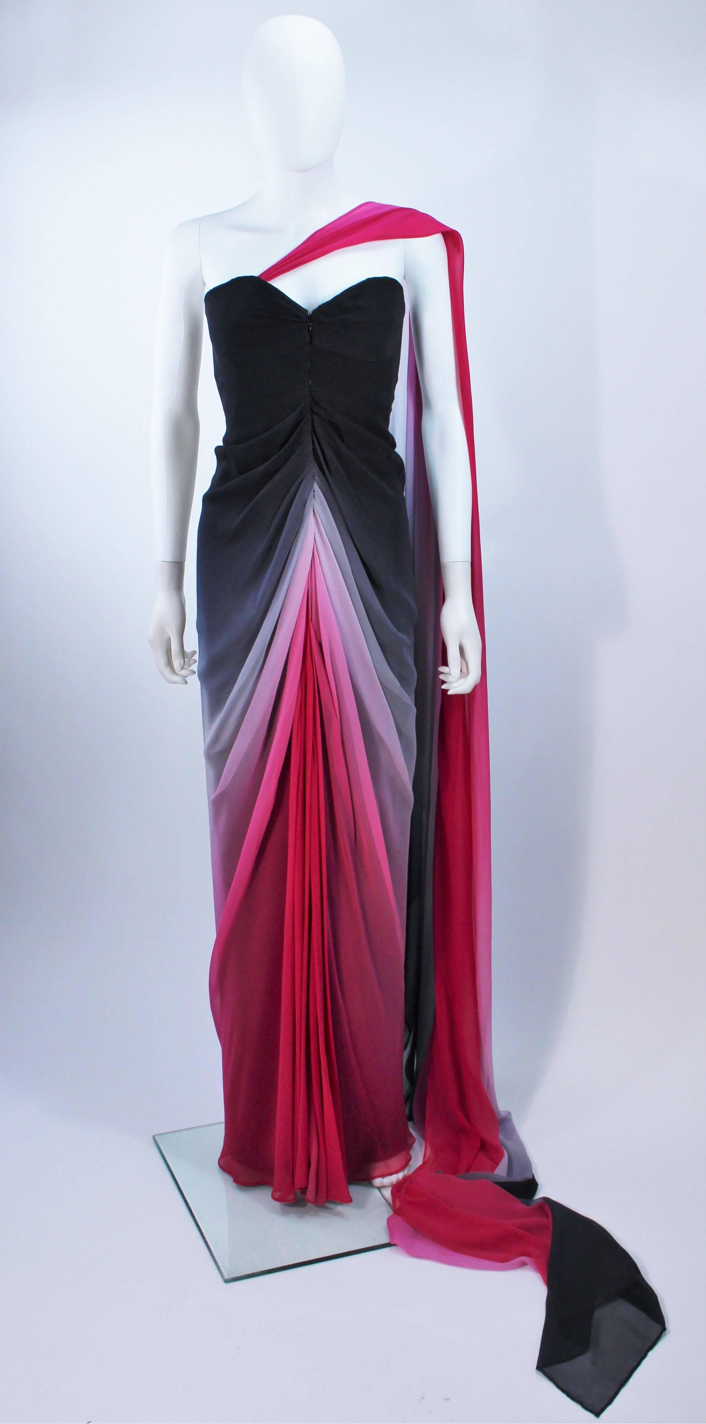 This Elizabeth Mason Couture  gown is composed of a stunning black to pink gradient silk. Features a draped style with center front closures and an interior bustier foundation. There is a removable piece, which drapes from the shoulder across the