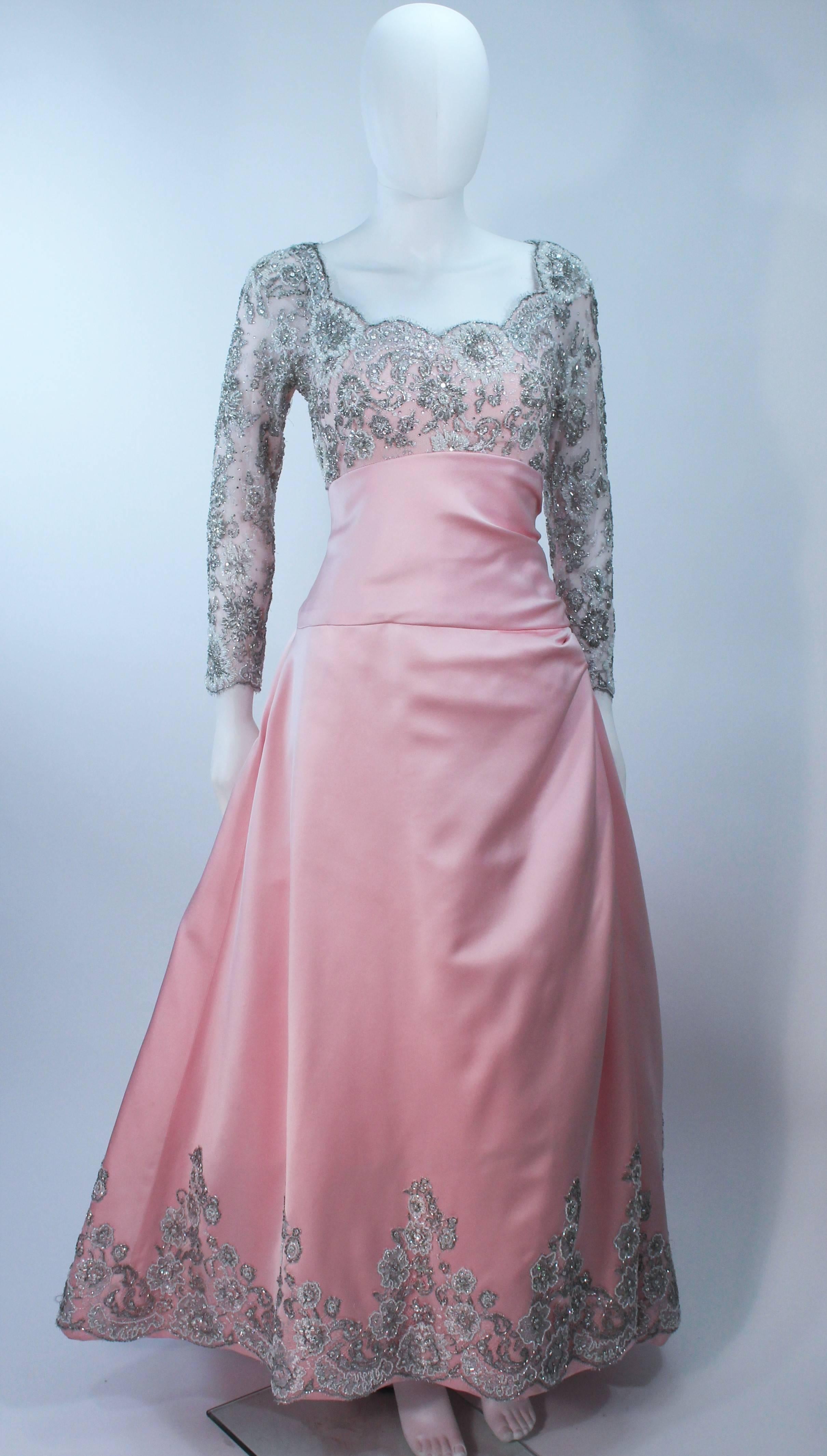  This Bob Mackie gown is composed of pink silk with a silver embellished lace applique. There is a center back zipper closure with buttons. In excellent vintage condition. 

  **Please cross-reference measurements for personal accuracy. Size in