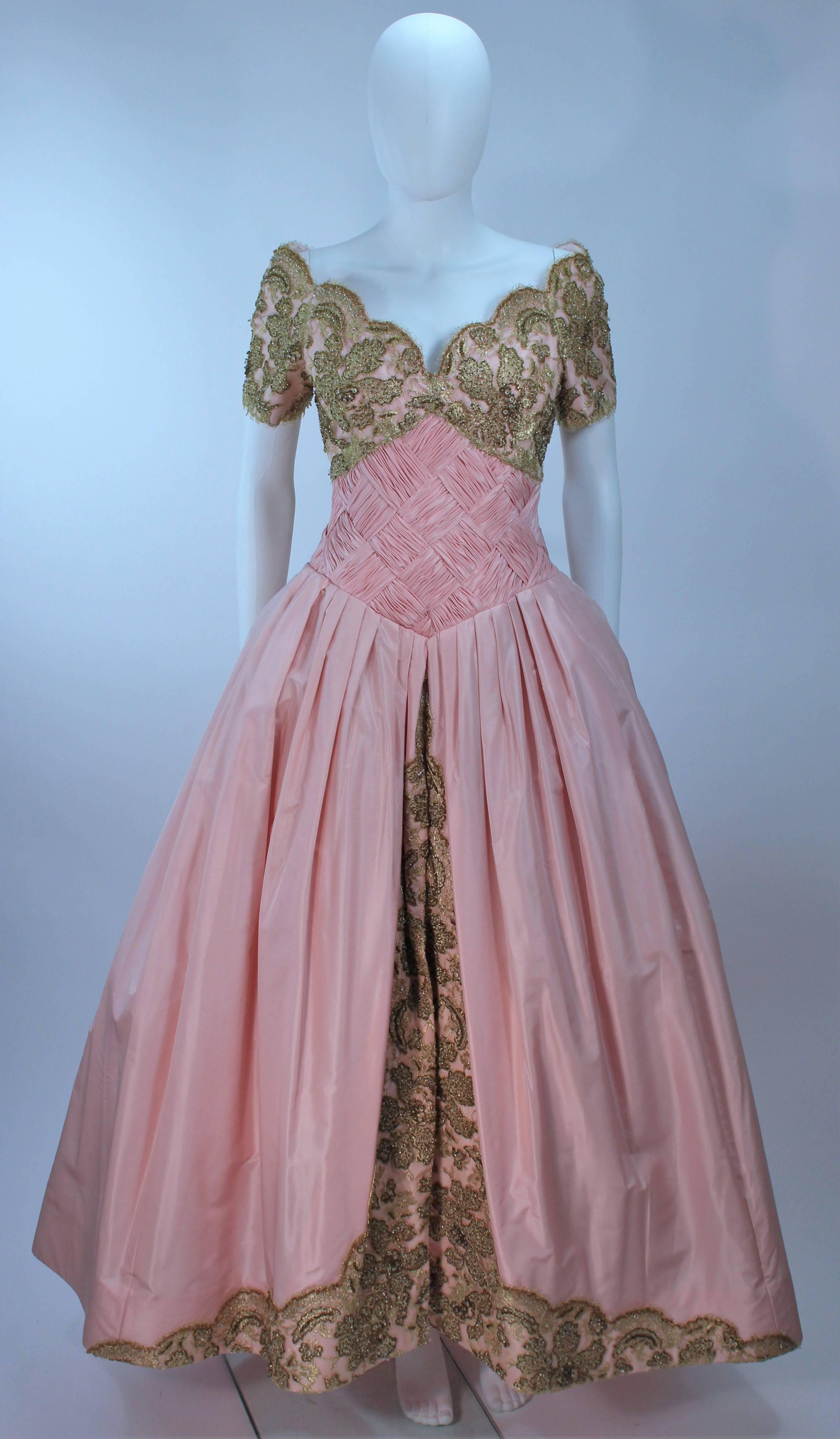  This Vera Wang gown is composed of pink silk, trimmed with beaded gold lace. There is a center back zipper closure, with interior boning and an off the shoulder design. Scalloped edging. In excellent vintage condition. 

  **Please